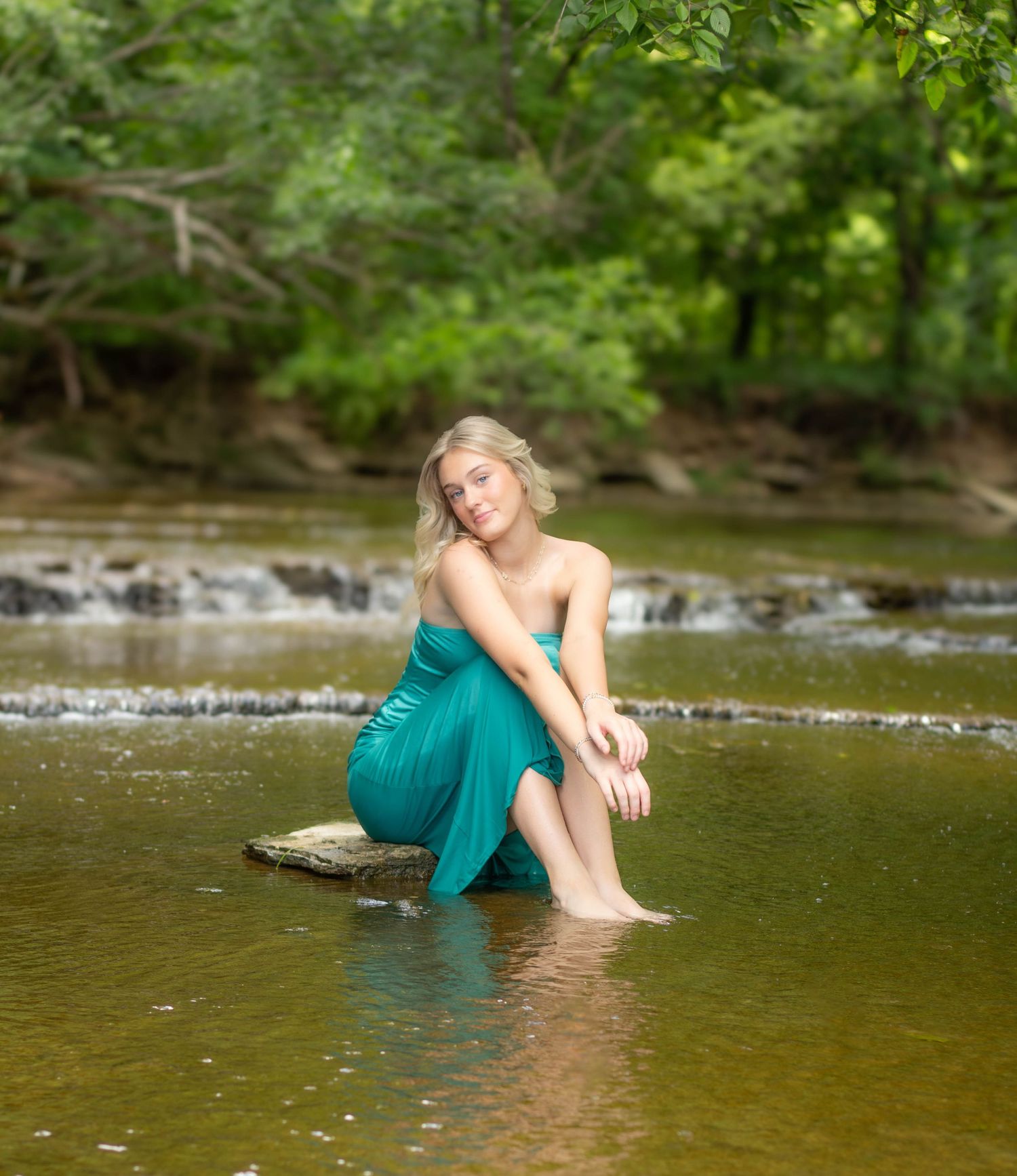 High school senior girl posing outdoors for a senior portrait session