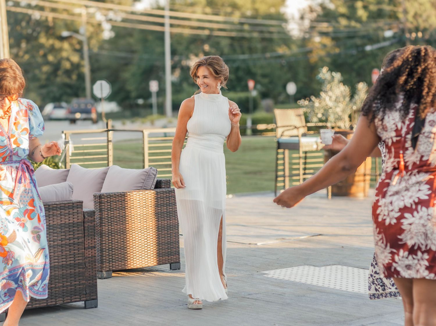 Wedding guest enjoying an outdoor reception surrounded by event seating and décor.