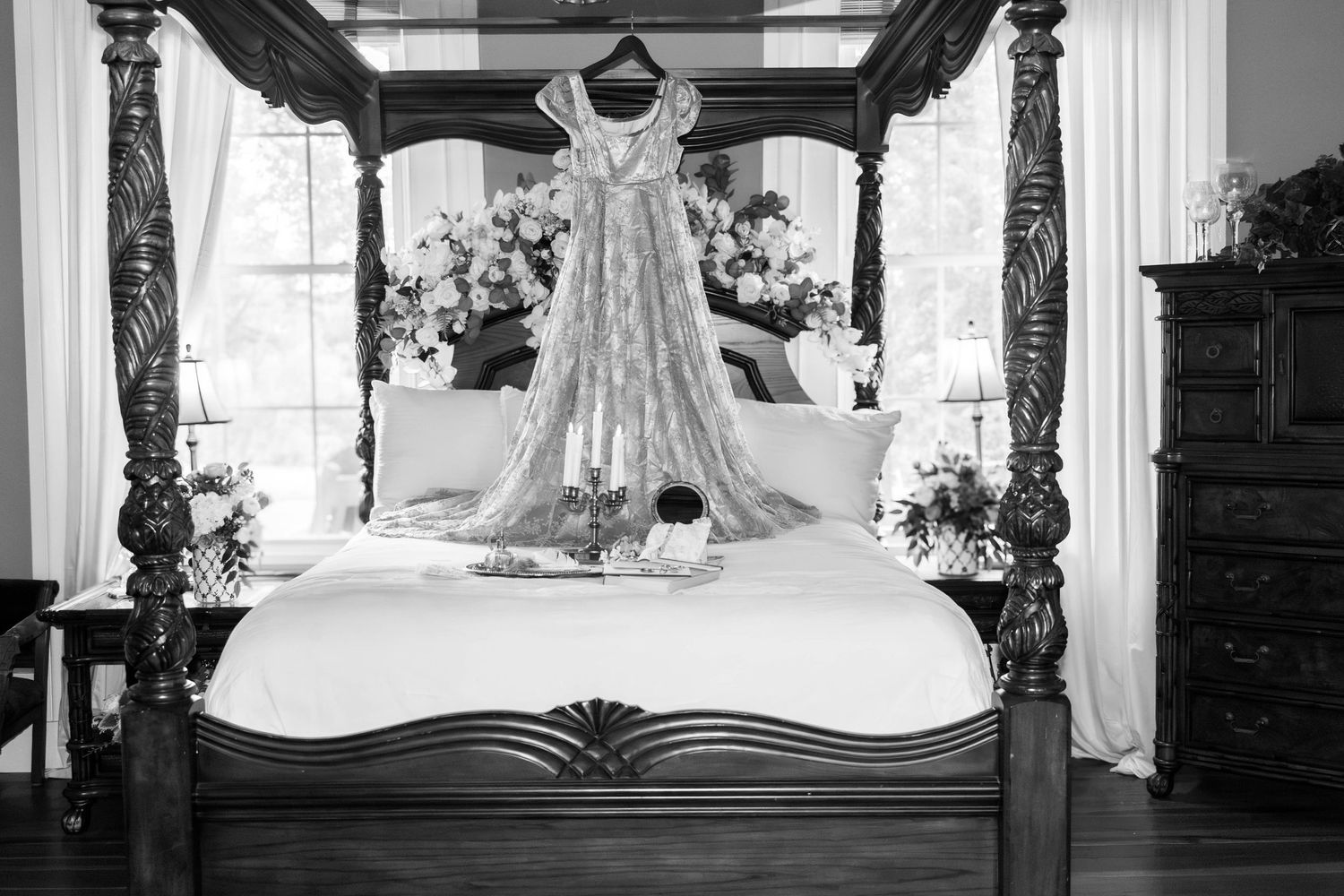 Black-and-white photo of a wedding dress displayed in the bridal suite.