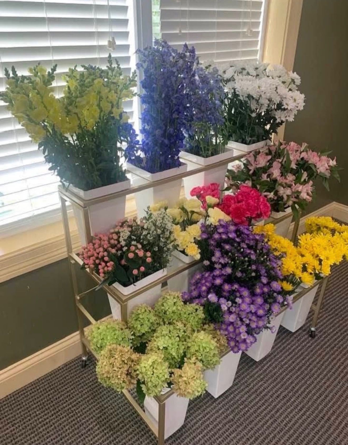 Freestanding flower bar filled with colorful flowers for weddings, showers, and events.