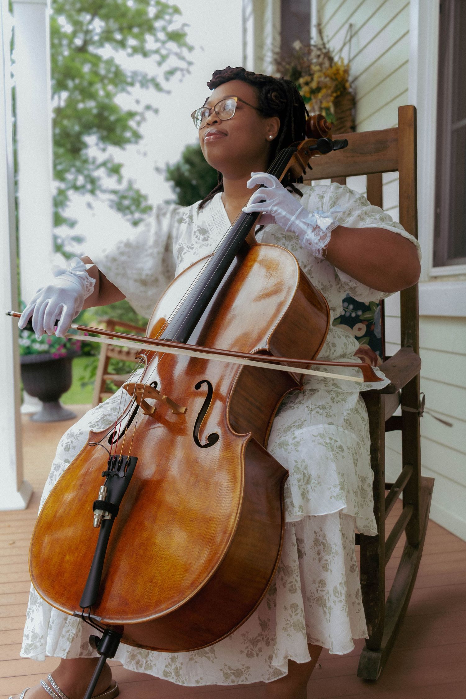 Cellist performing beside a window during a wedding.