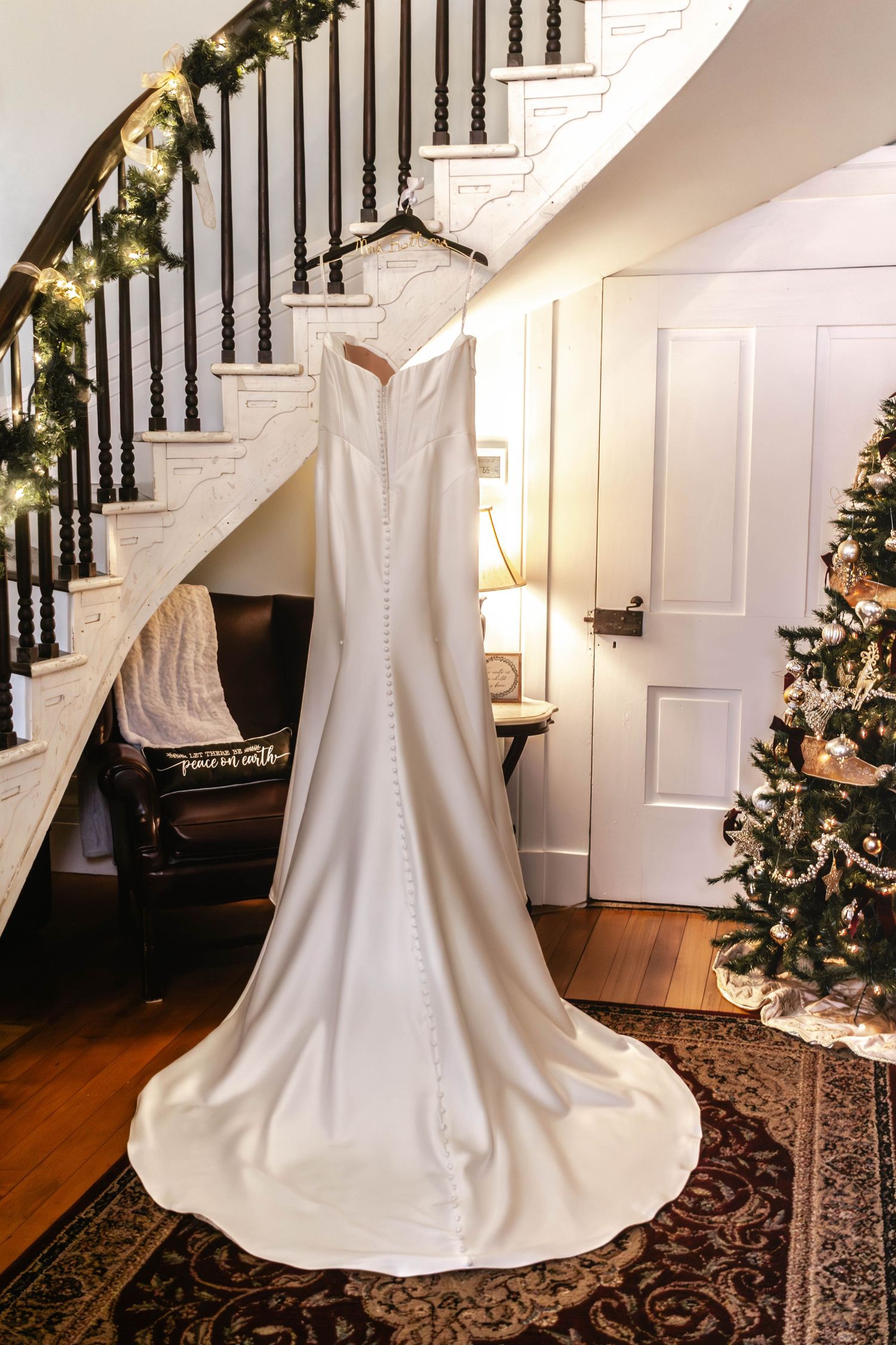 Wedding dress displayed beside a staircase before the ceremony.