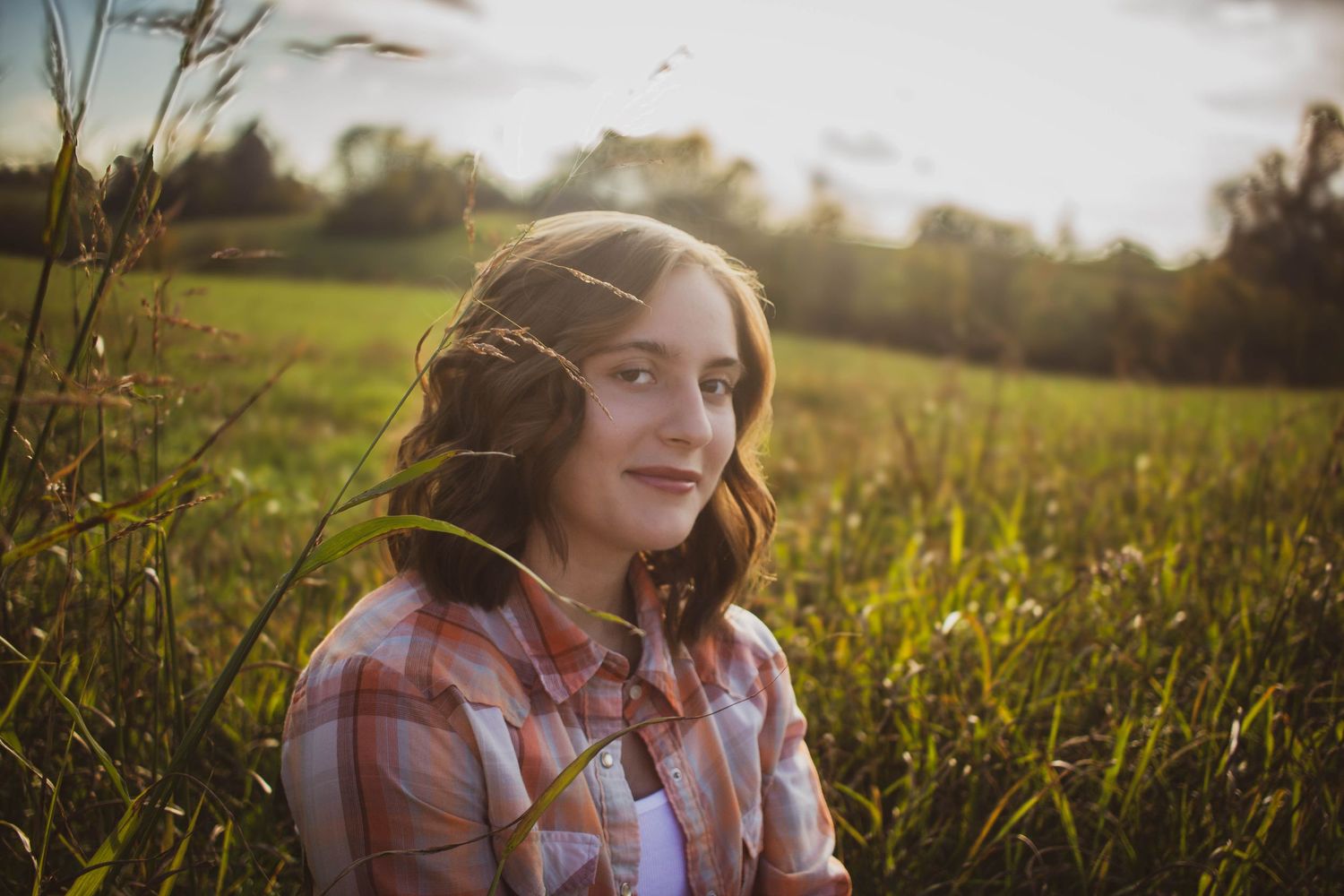 High school senior girl posing outdoors for a senior portrait session