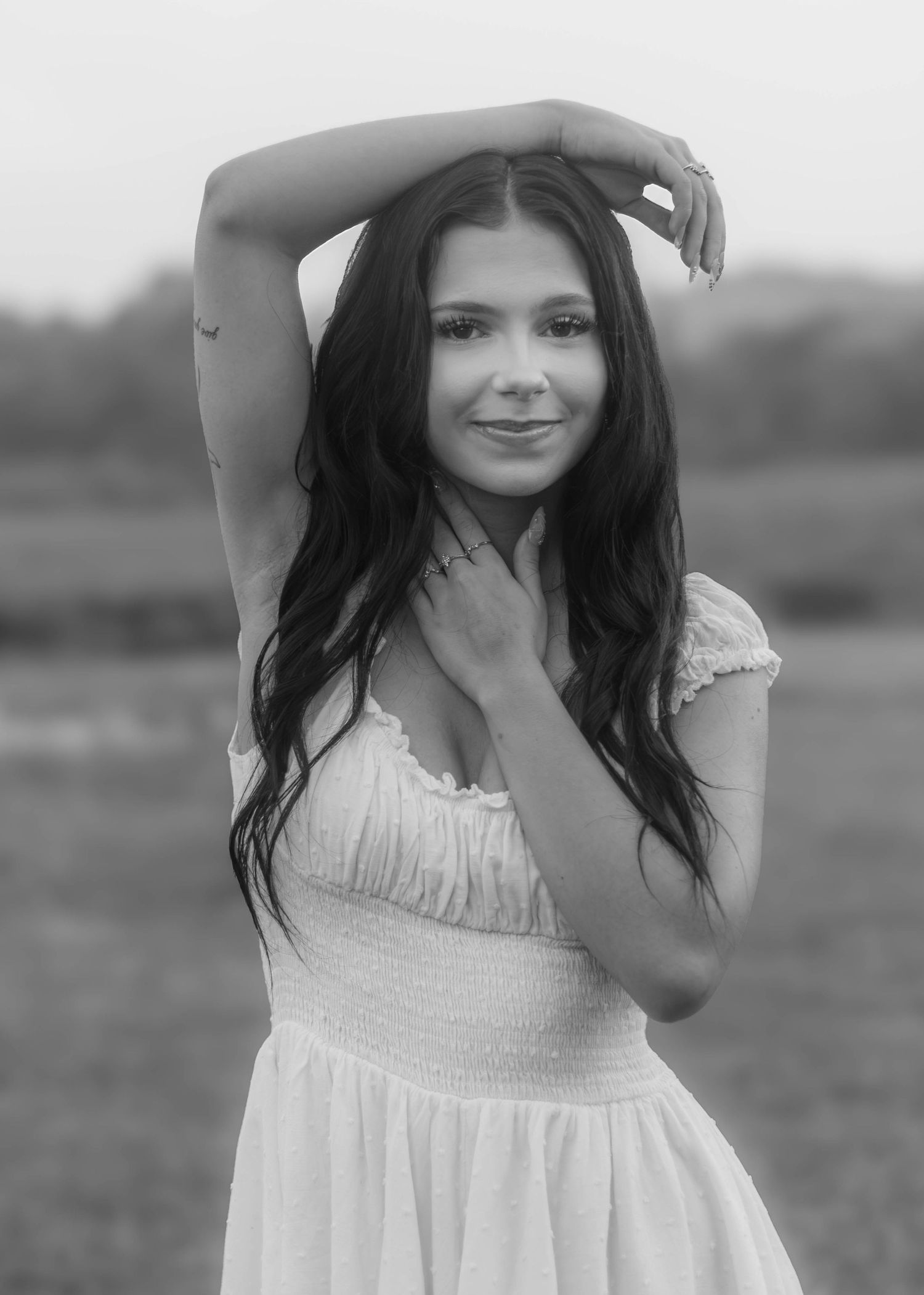 High school senior girl posing outdoors for a senior portrait session