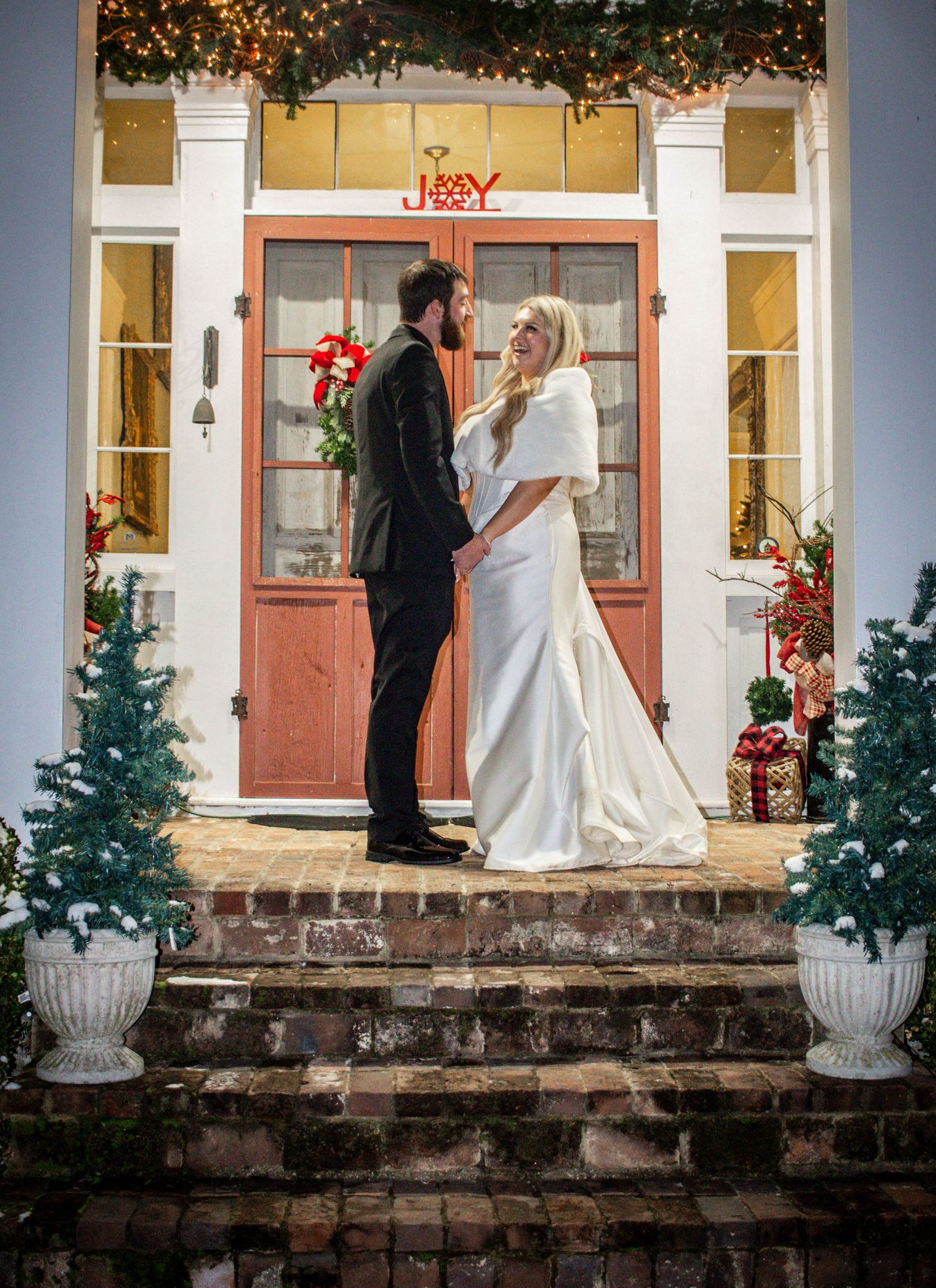 Bride and groom standing together on the steps of a wedding venue.