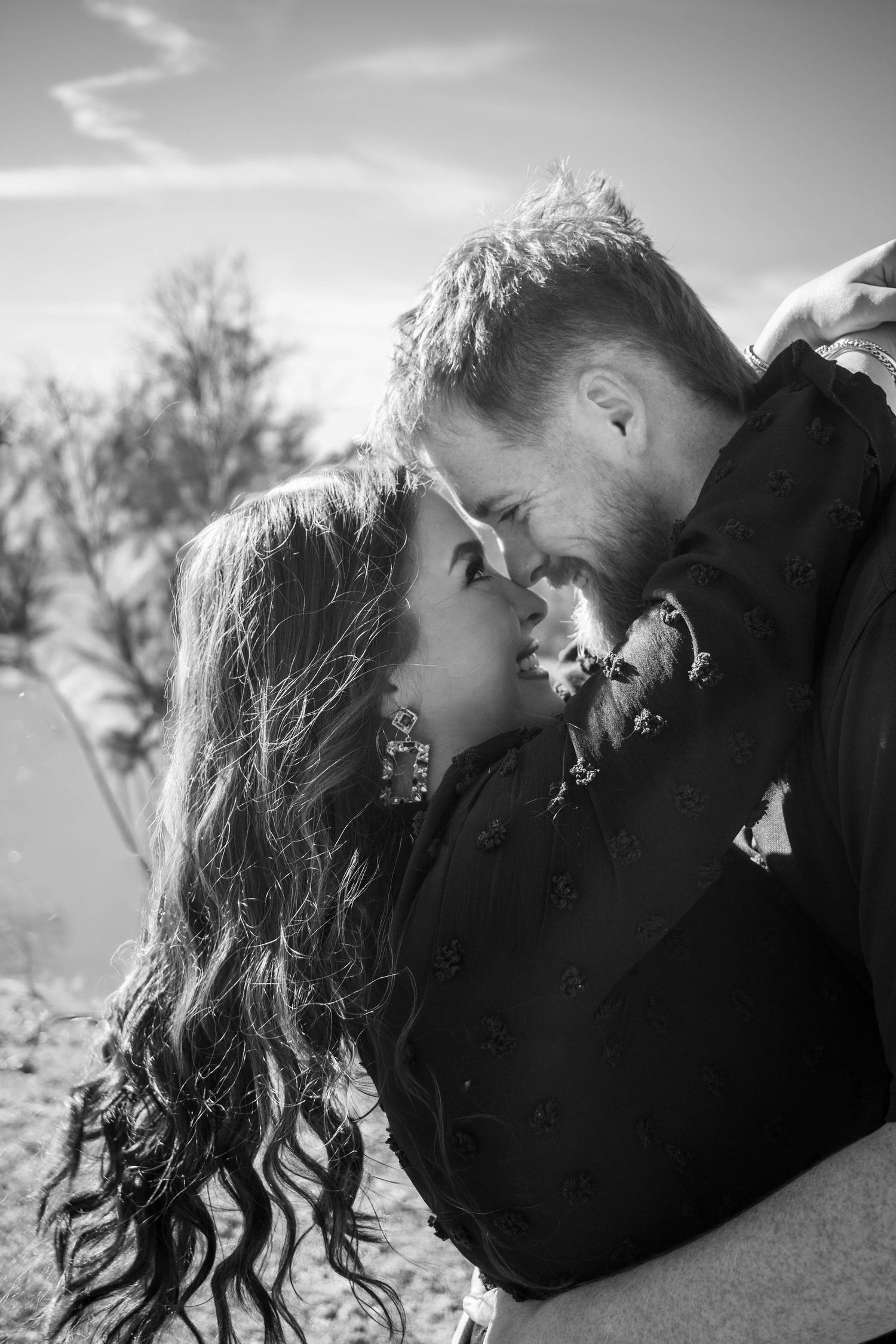 Black-and-white close-up of a couple sharing a romantic moment.