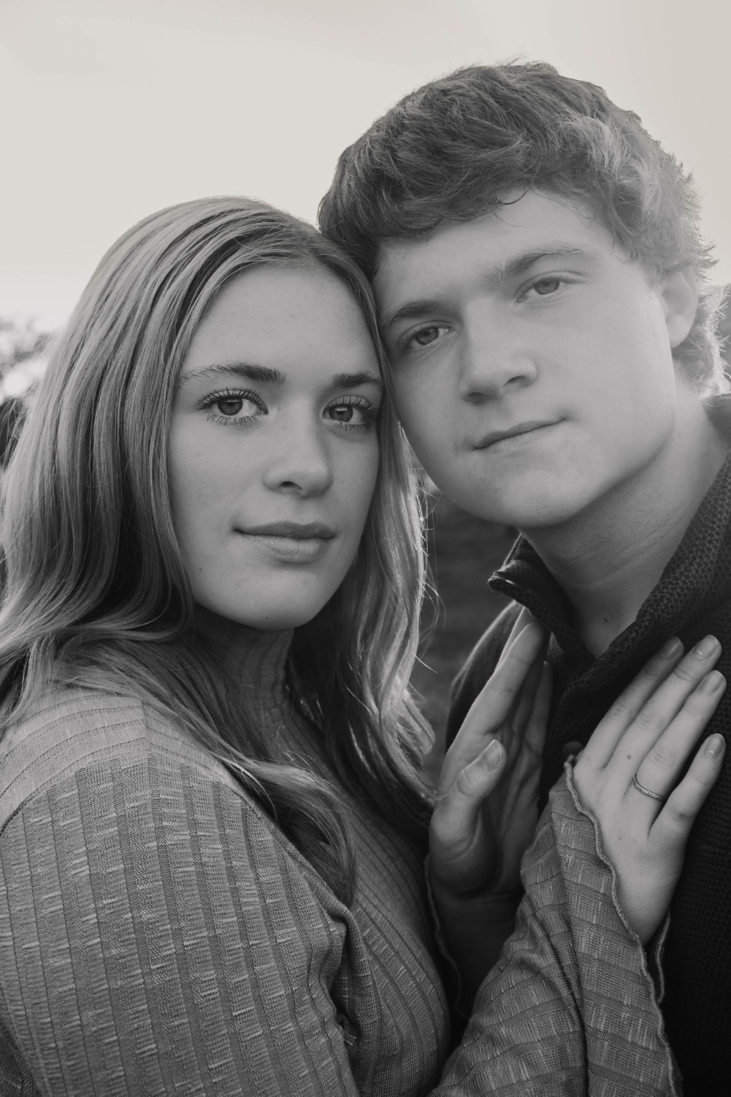 Black-and-white close-up portrait of a couple together.