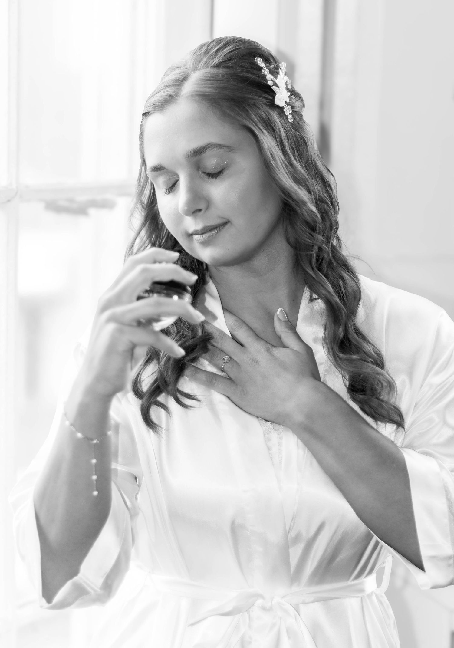 Bride with softly curled wedding hairstyle and delicate floral hair accessories.