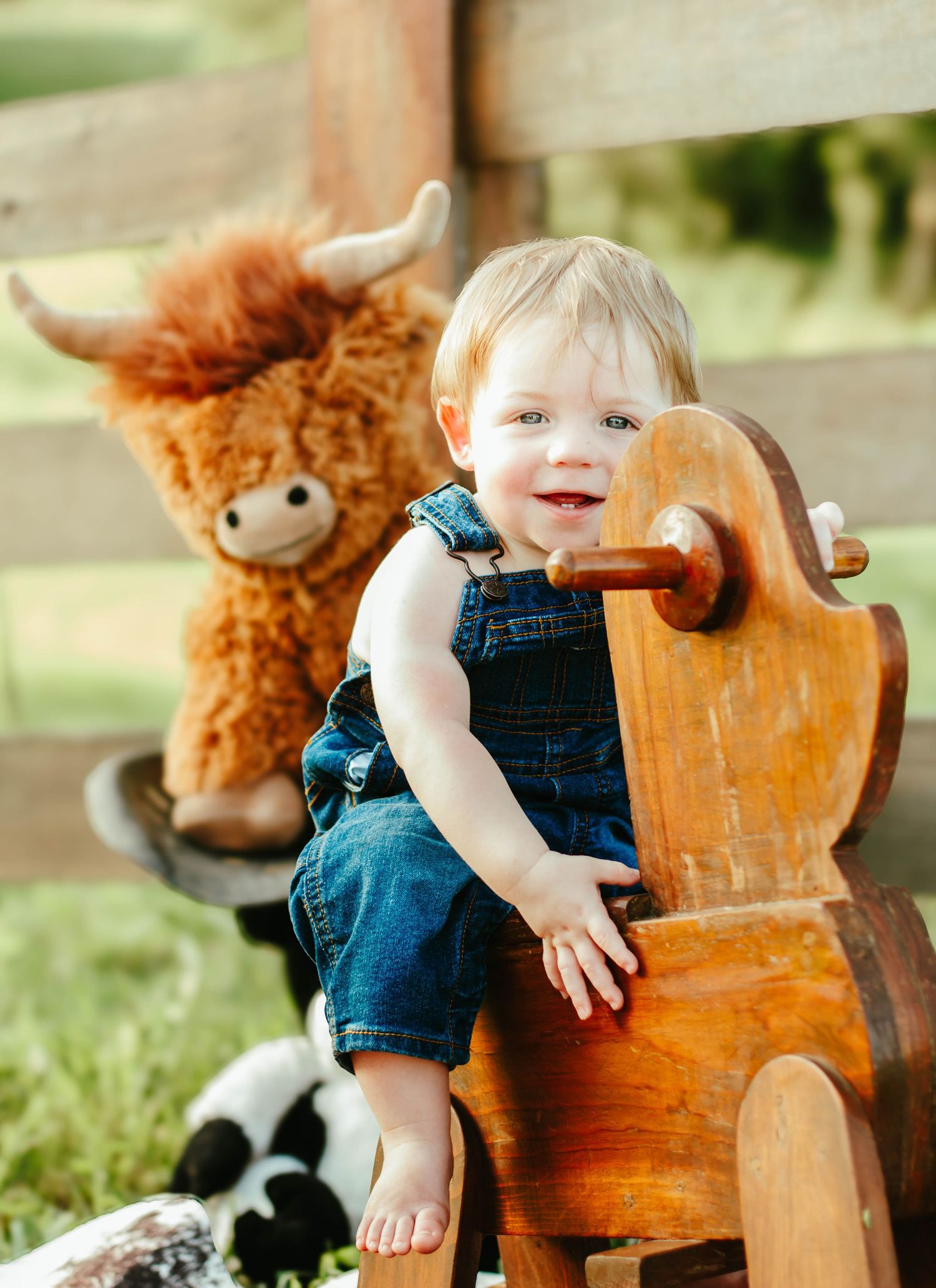 Baby posing with a toy rocking horse during a western-themed milestone session.