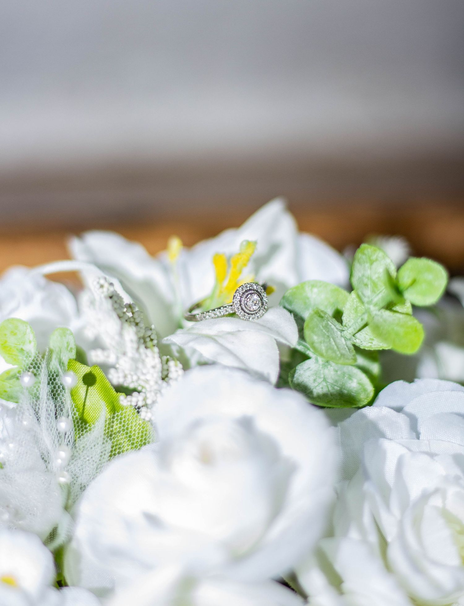 Close-up of a soft white bridal bouquet with ring