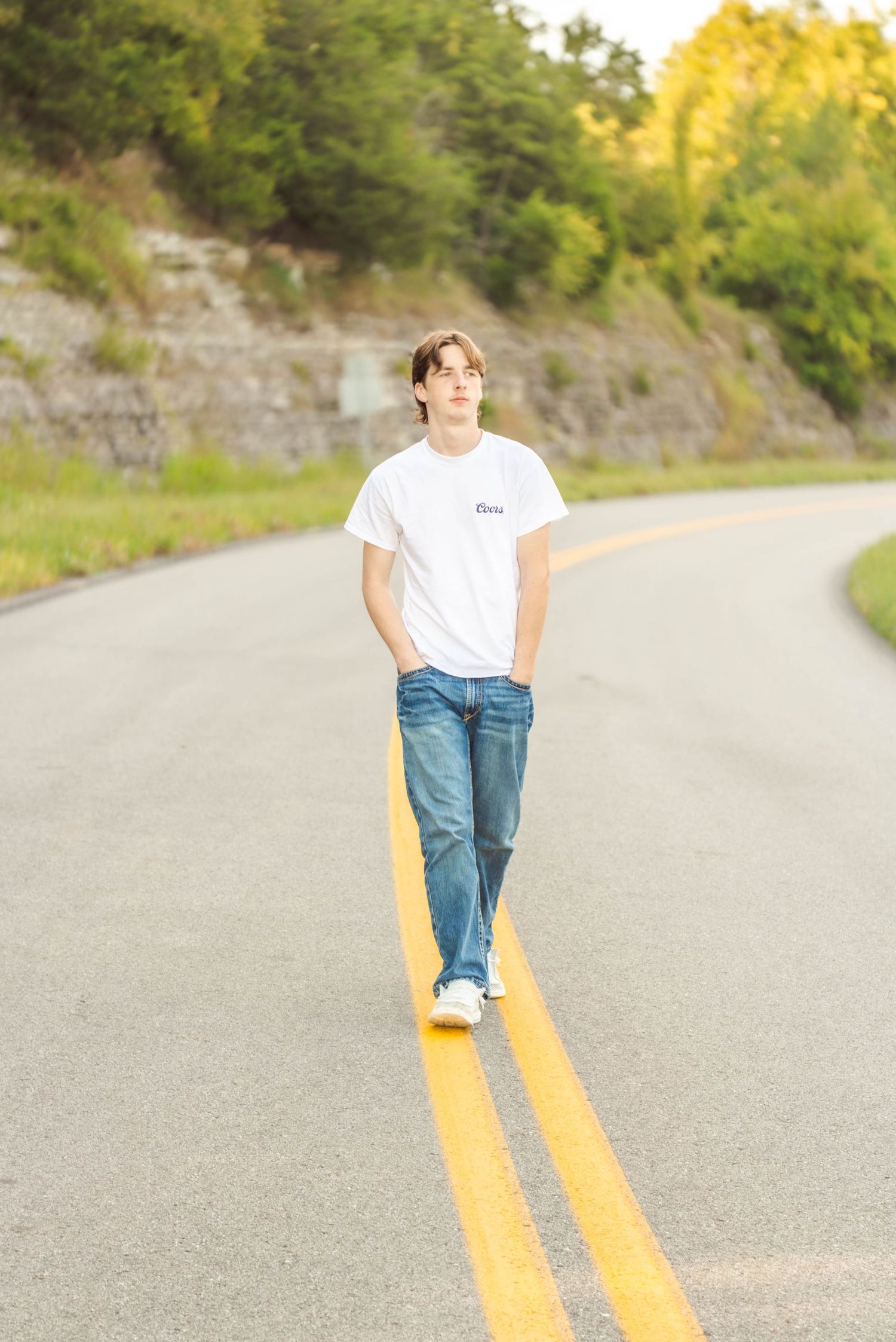 High school senior boy posing outdoors for a senior portrait session