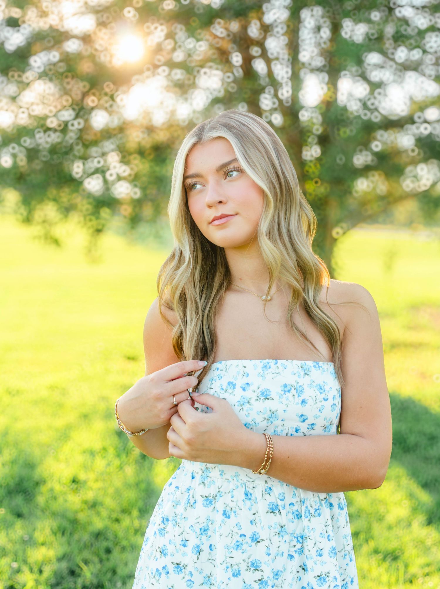 High school senior girl posing outdoors for a senior portrait session