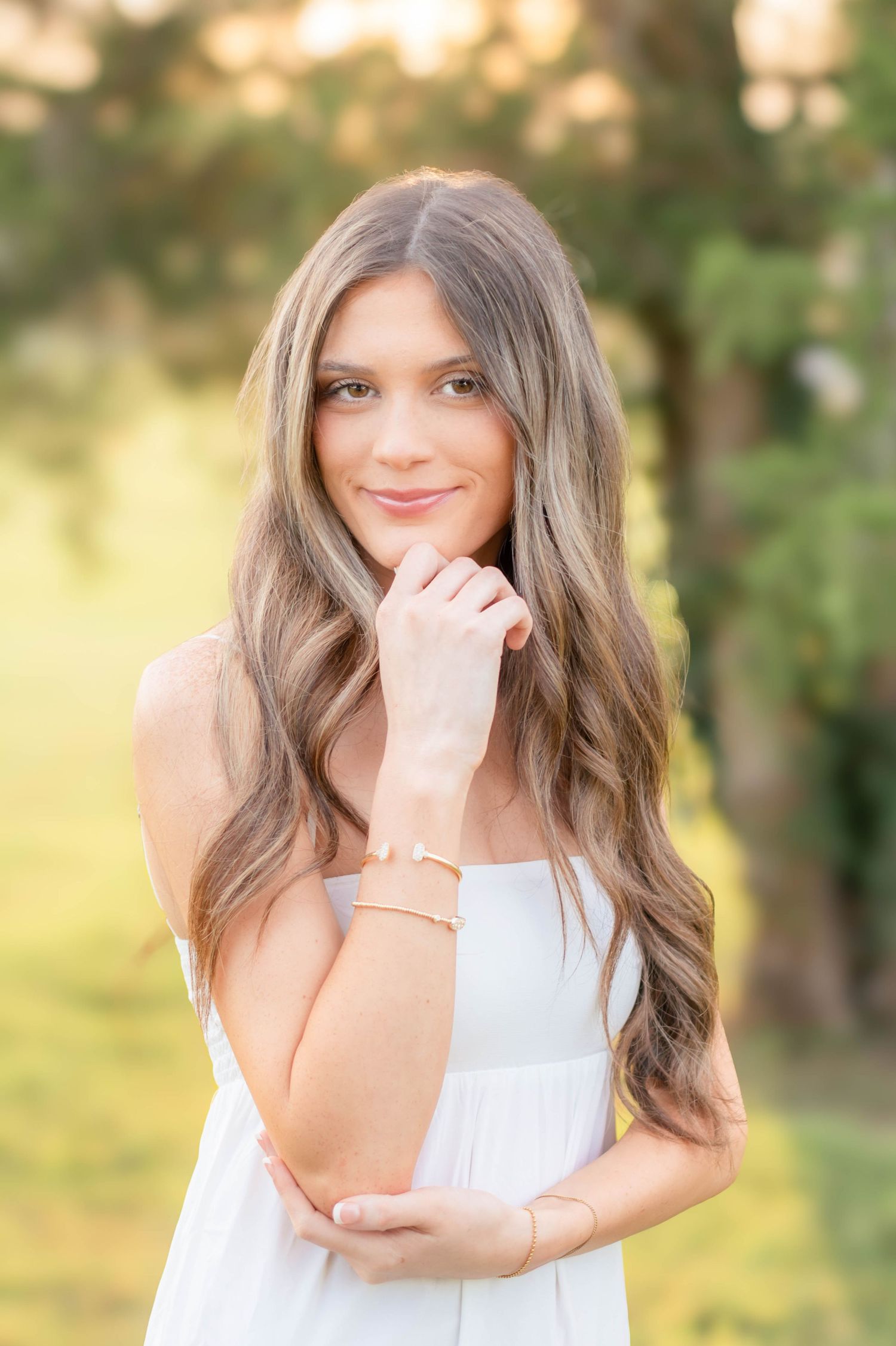 High school senior girl posing outdoors for a senior portrait session