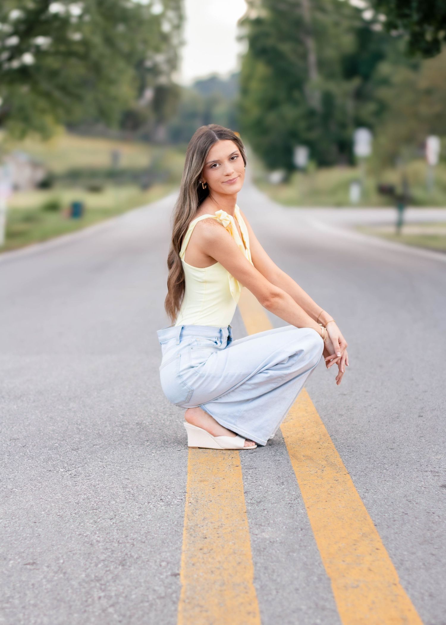 High school senior girl posing outdoors for a senior portrait session