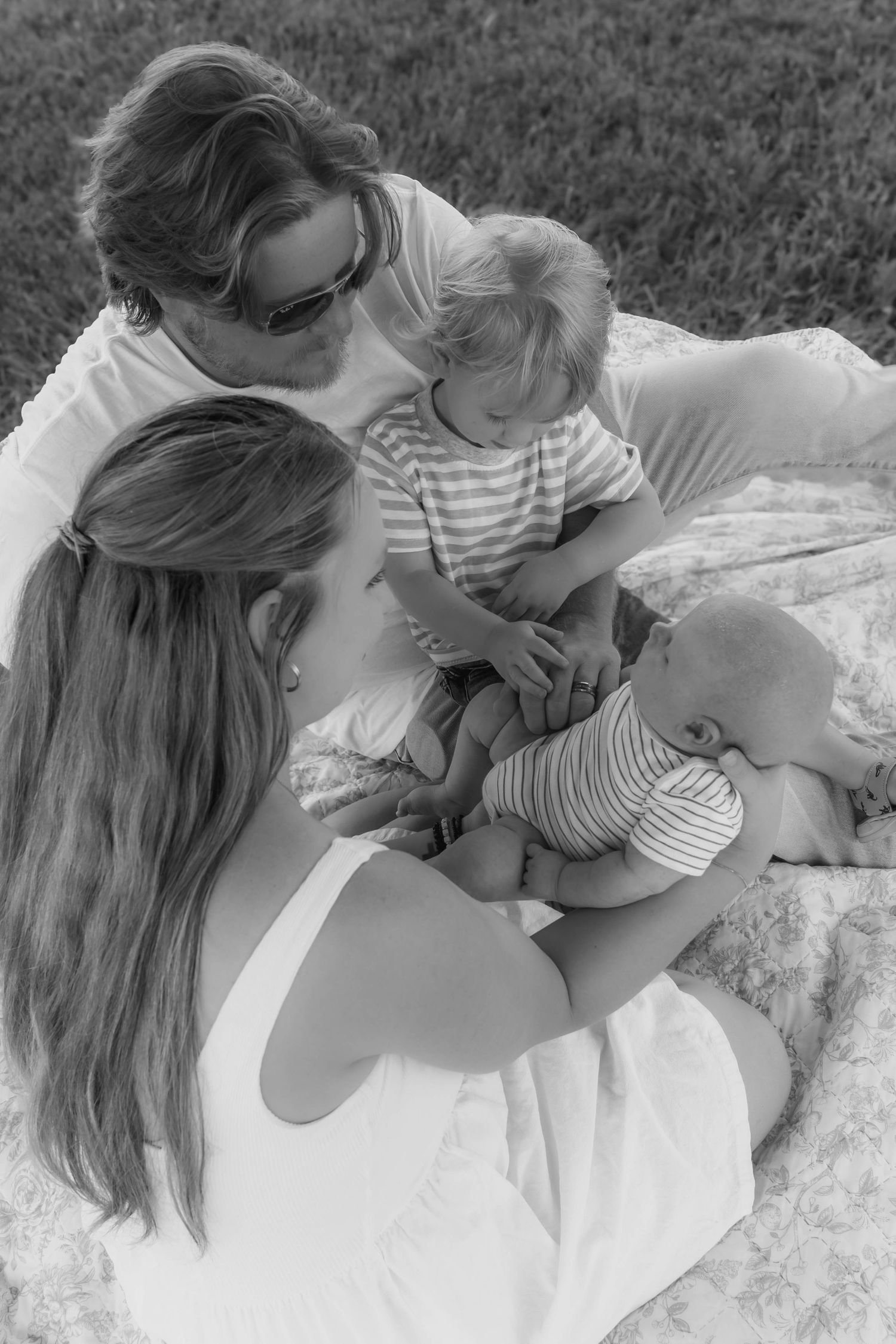 Mother hugging her two sons during an outdoor family photography session