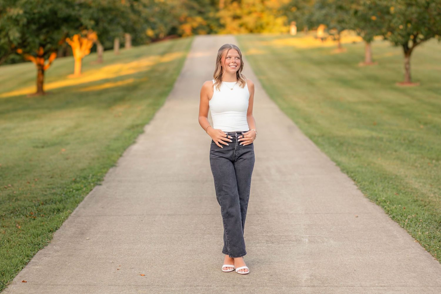 High school senior girl posing outdoors for a senior portrait session