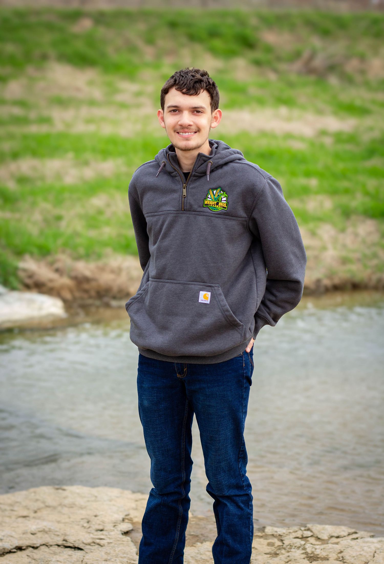 High school senior boy posing outdoors for a senior portrait session