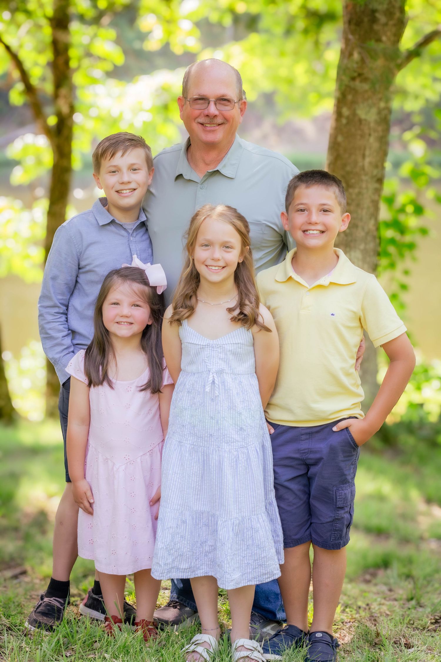 Group of children posing together outdoors during a family session