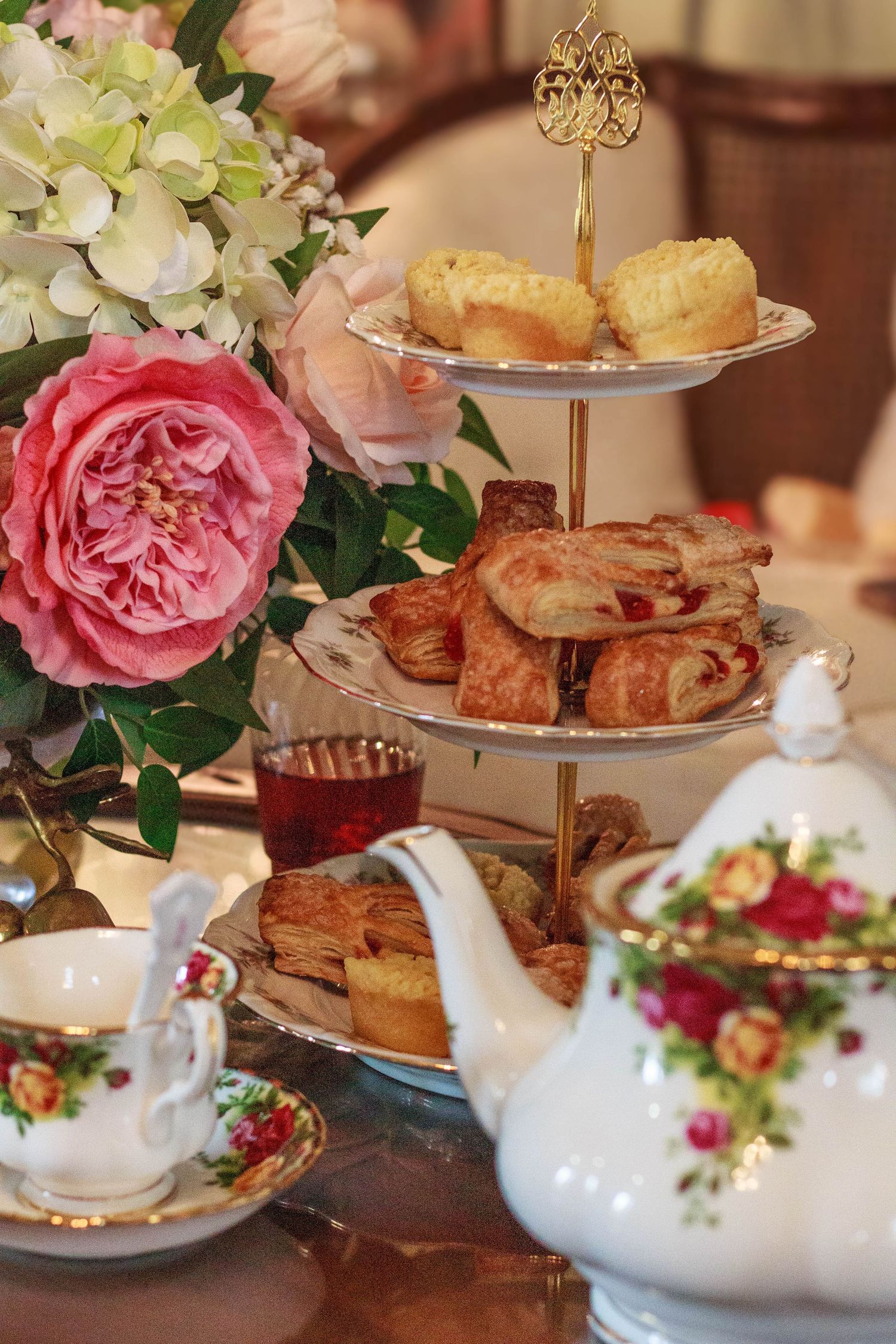 Wedding dessert table decorated with colorful flowers and treats