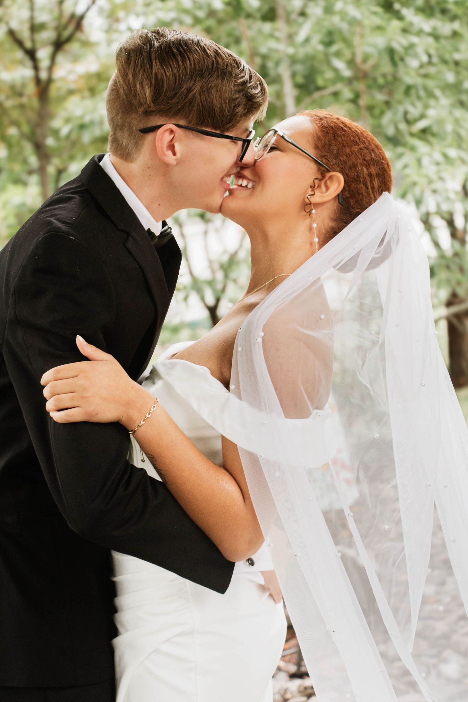 bride and groom kissing under veil