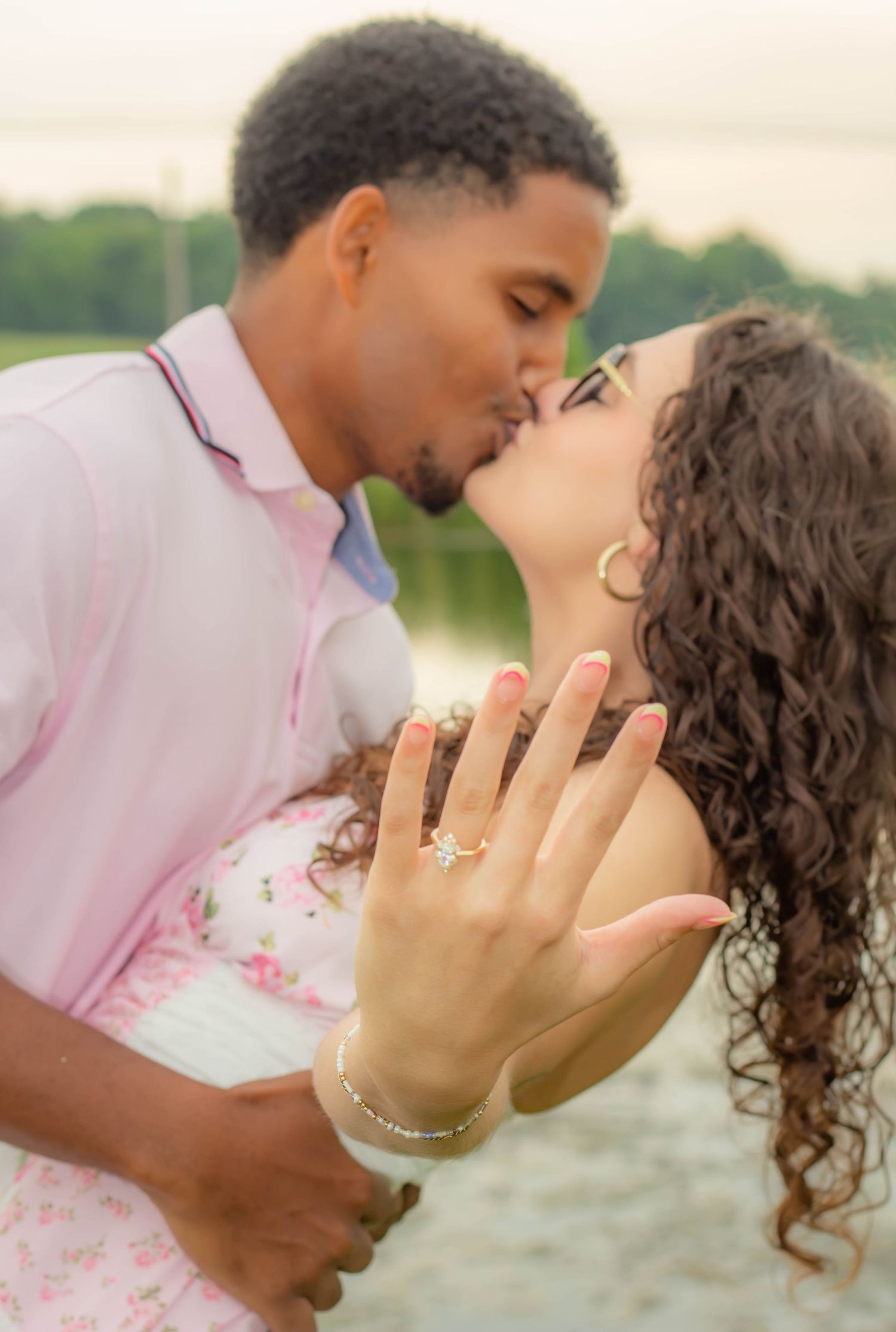 Couple kissing during an outdoor engagement session.