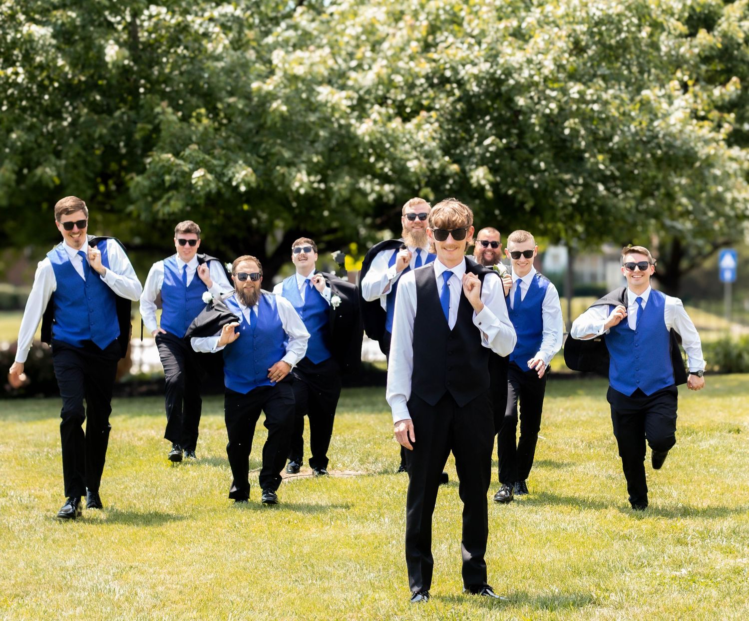 Groomsmen walking together outdoors before the wedding ceremony
