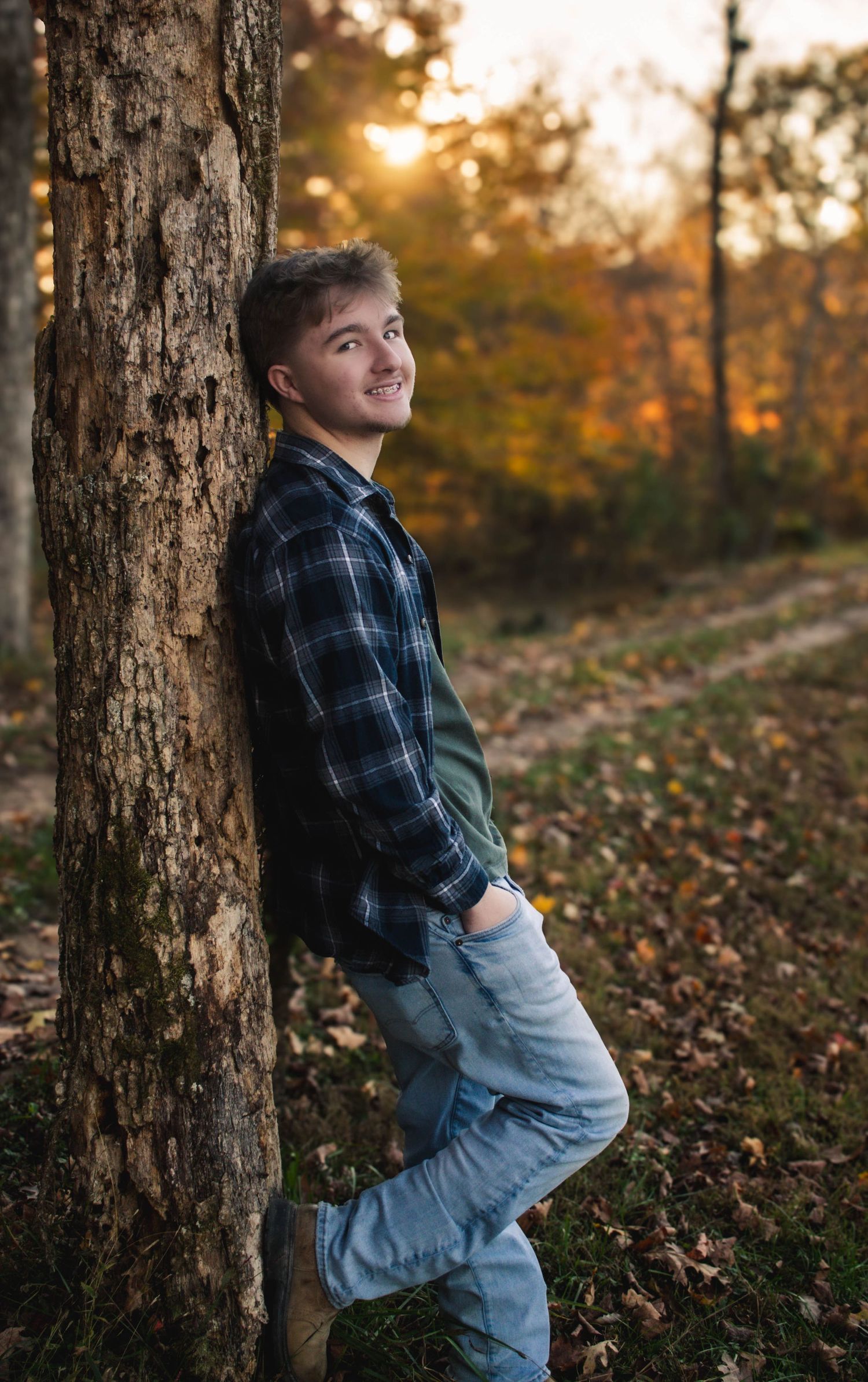 High school senior boy posing outdoors for a senior portrait session