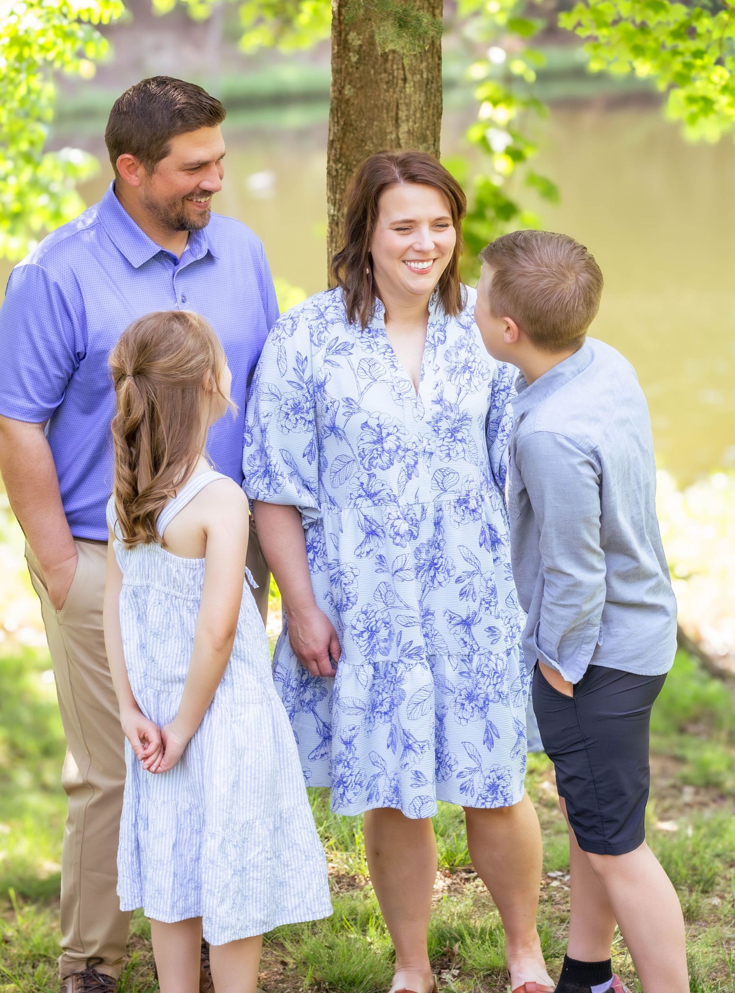 Family laughing and interacting together during an outdoor photography session