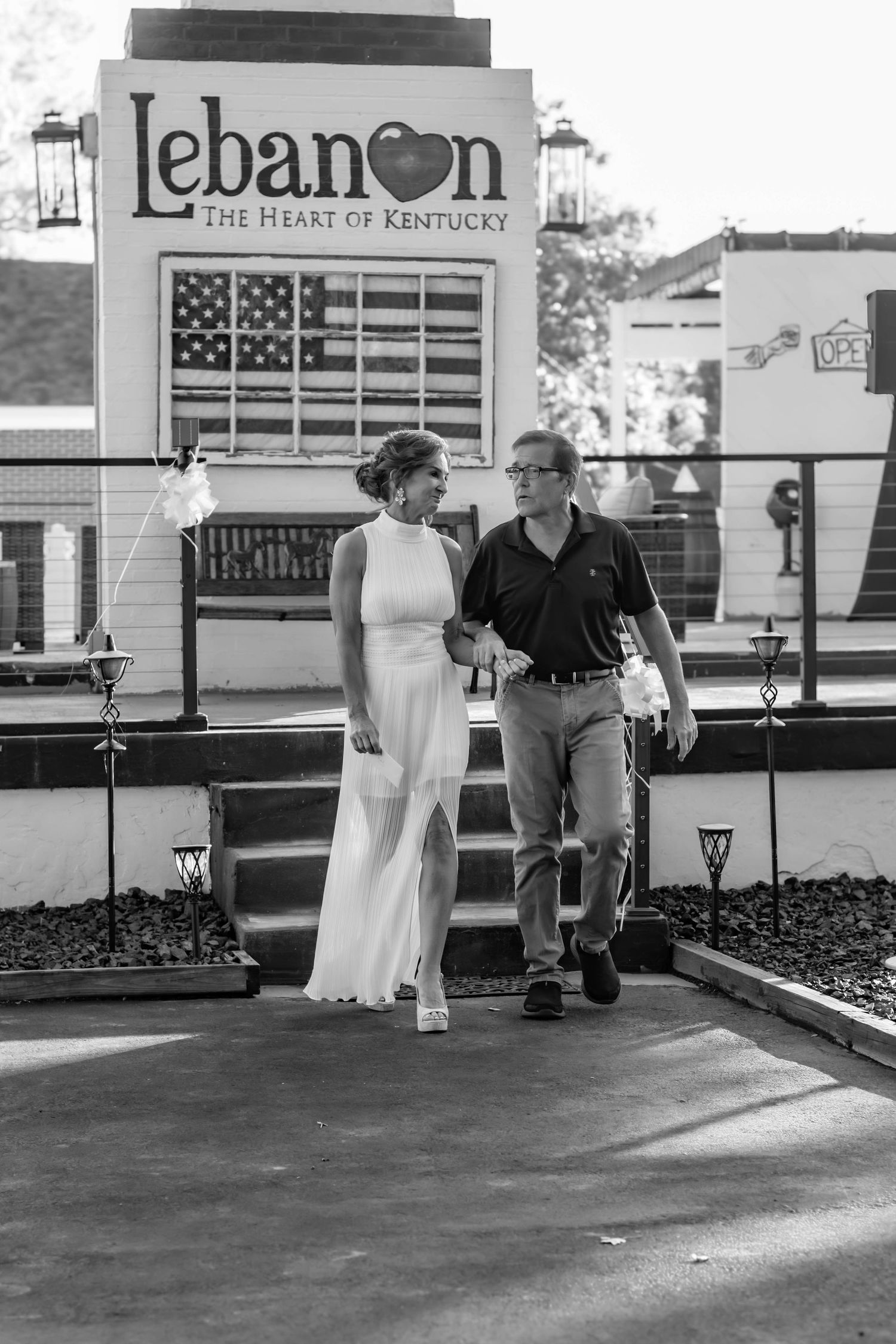 Bride and groom posing together near a Lebanon sign.