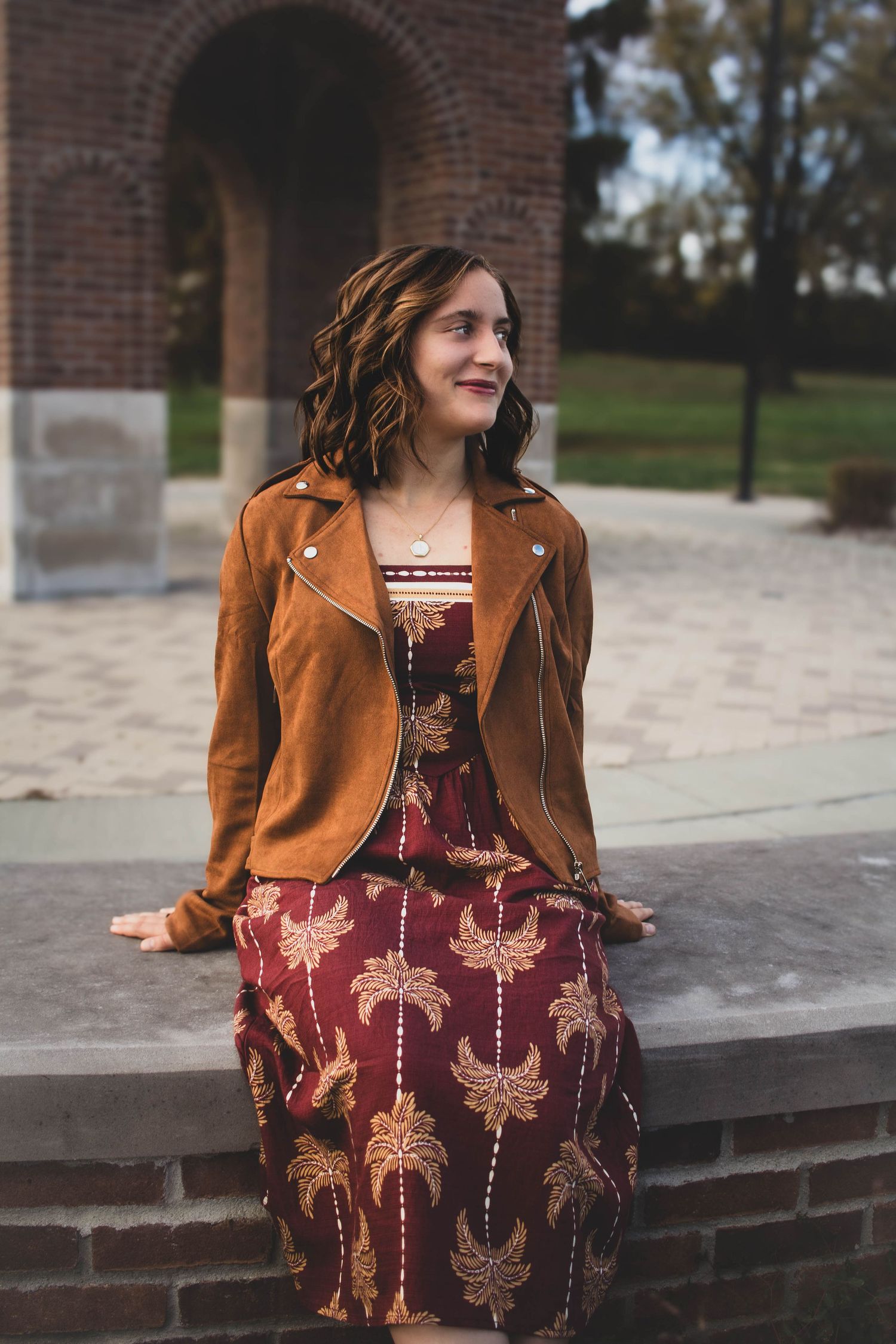 High school senior girl posing outdoors for a senior portrait session