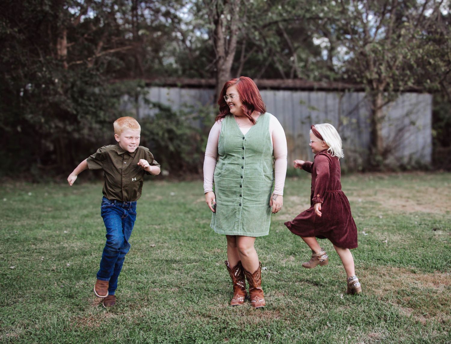 Children running and playing with their mother during a candid family session