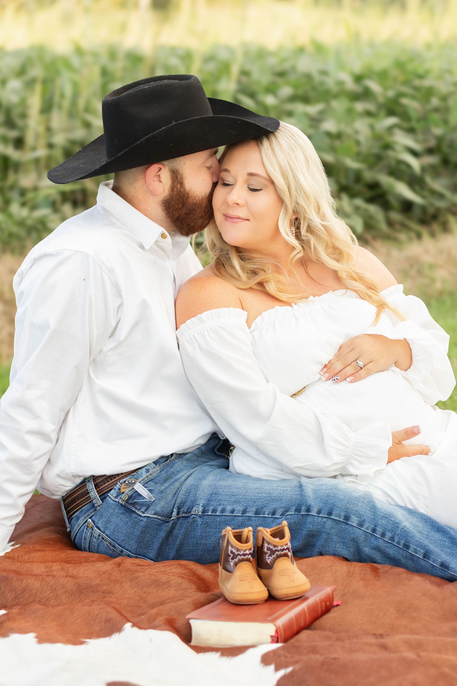 Expecting couple posing together outdoors during a maternity photography session.”