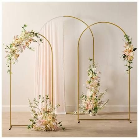 Set of three graduated-height gold arch stands for wedding florals and event backdrops.