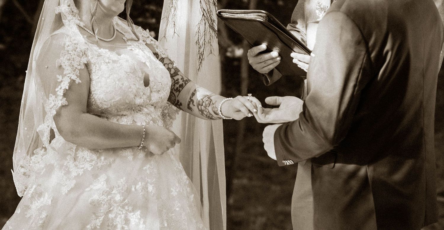 Black-and-white wedding ceremony moment with the bride and groom.