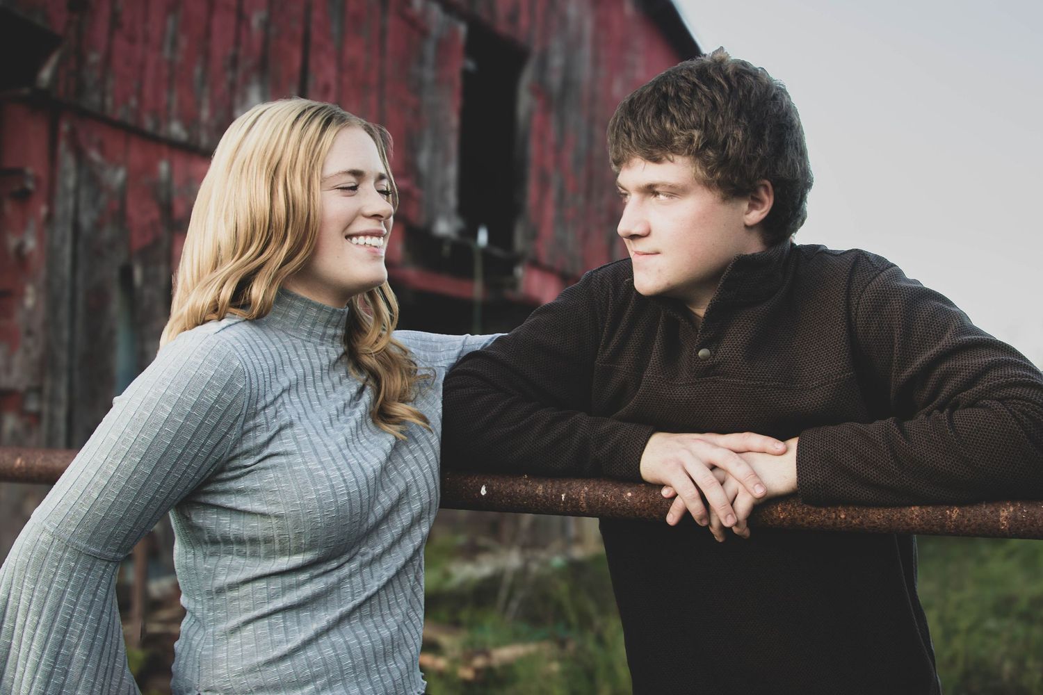 Couple leaning toward each other during a casual portrait session.