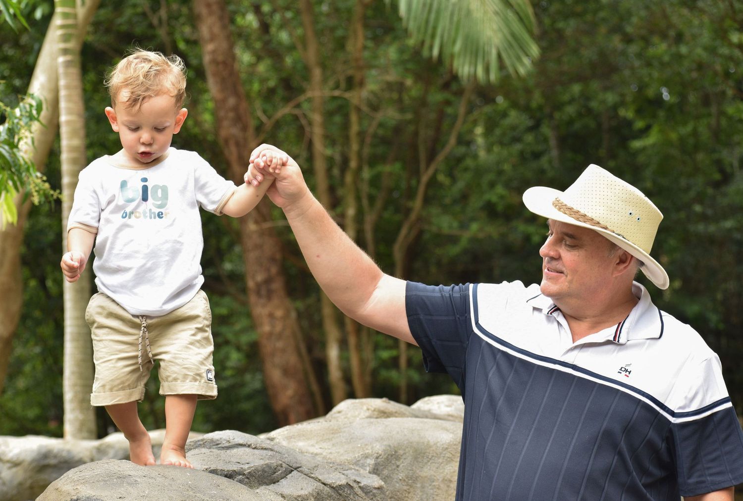 Candid picture between a grandfather and his first grandson at the zoo.