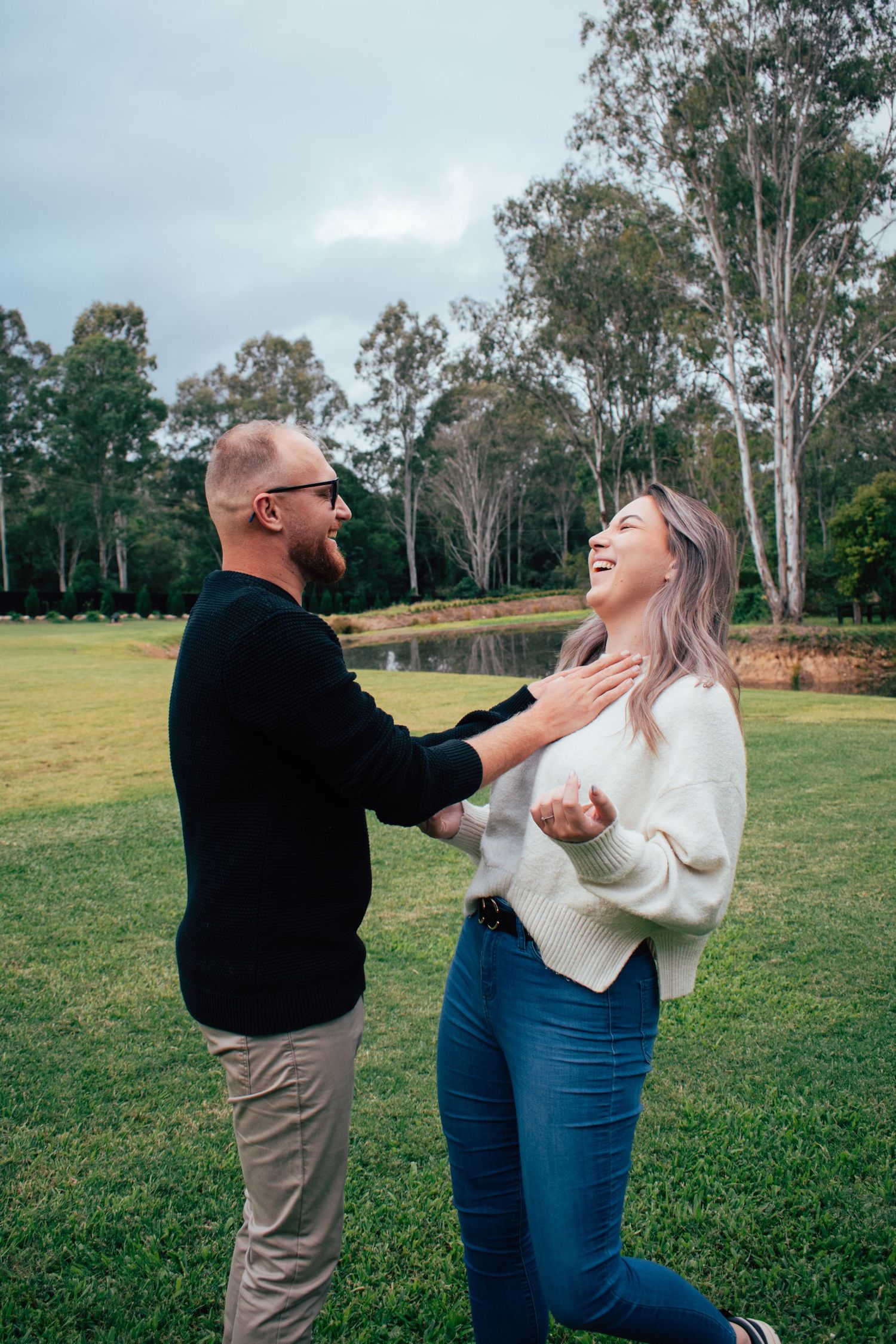 Candid picture of a couple sharing a laugh on their engagement photoshoot in Brisbane.