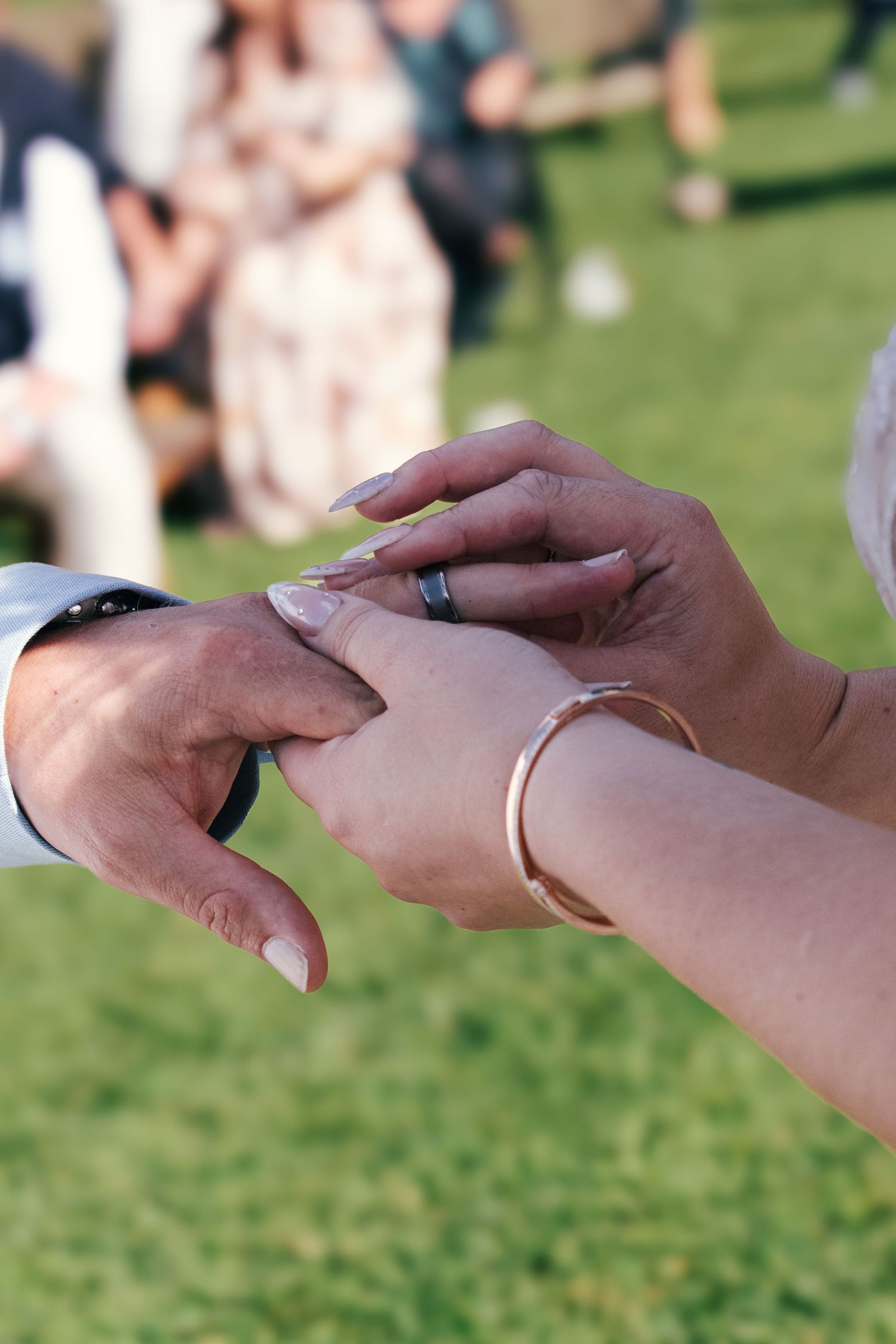 Close-up picture of the wedding bands of a couple in Brisbane.