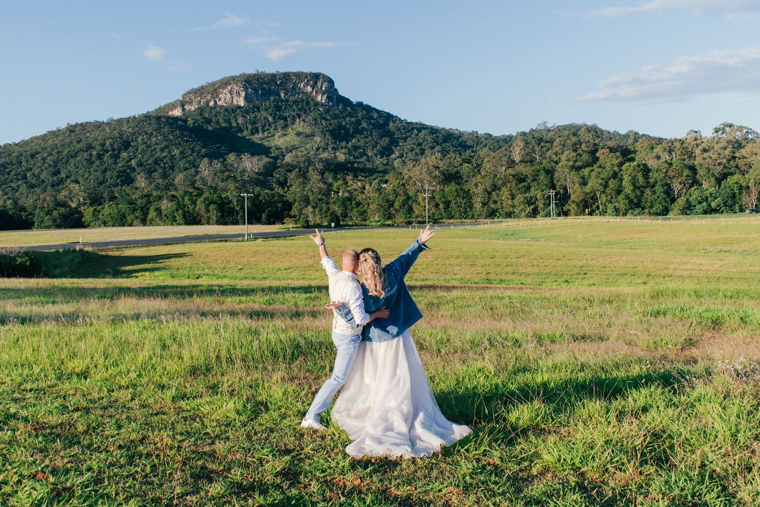 Bride and groom captured having a blast whilst taking their wedding pictures.