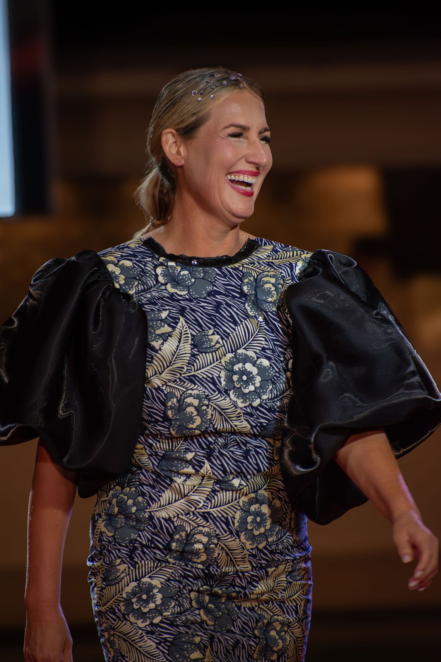Genuine laughter shared on the runway at a fashion show.
