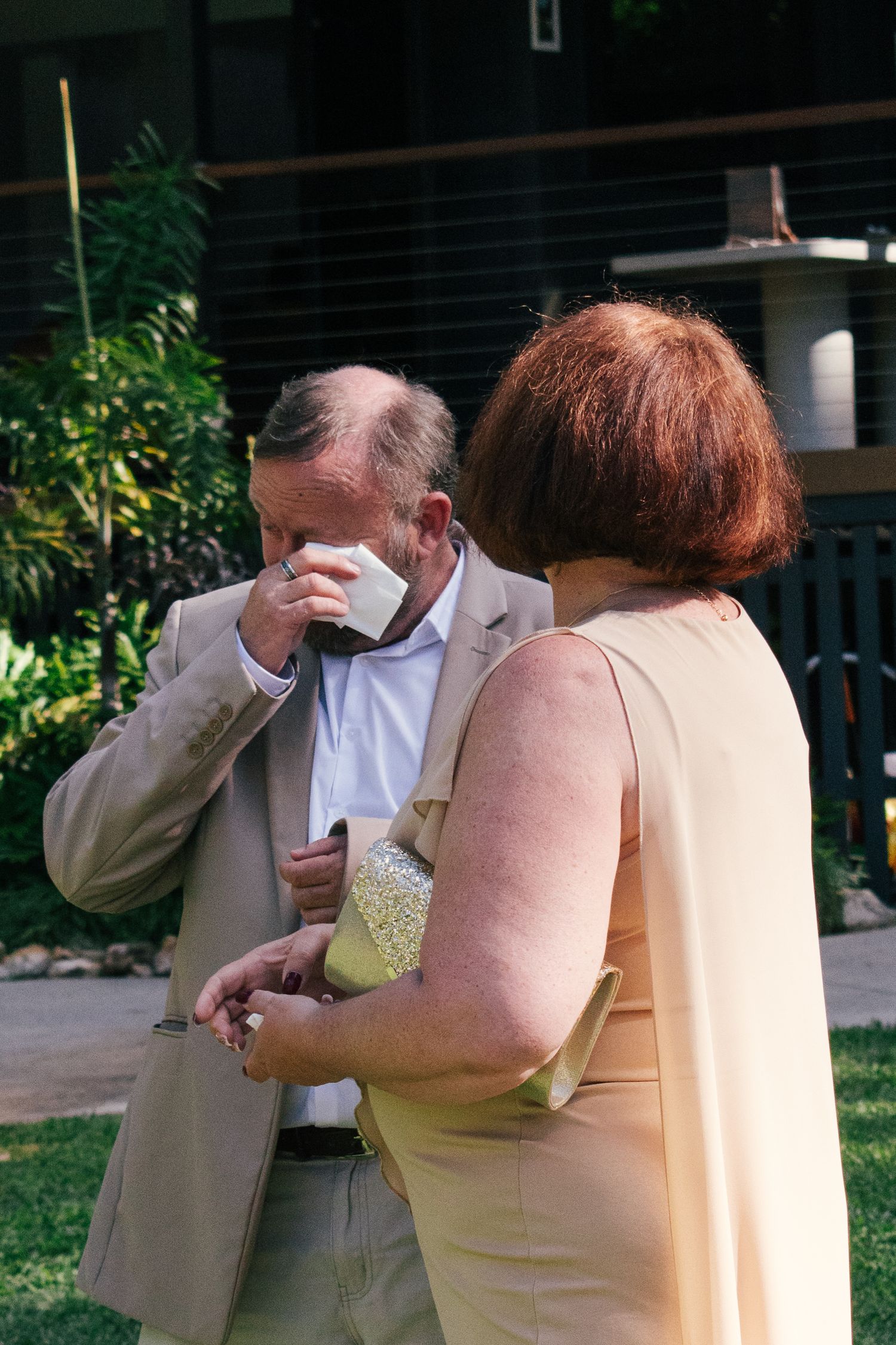 Guests crying happy tears at an outdoor wedding.