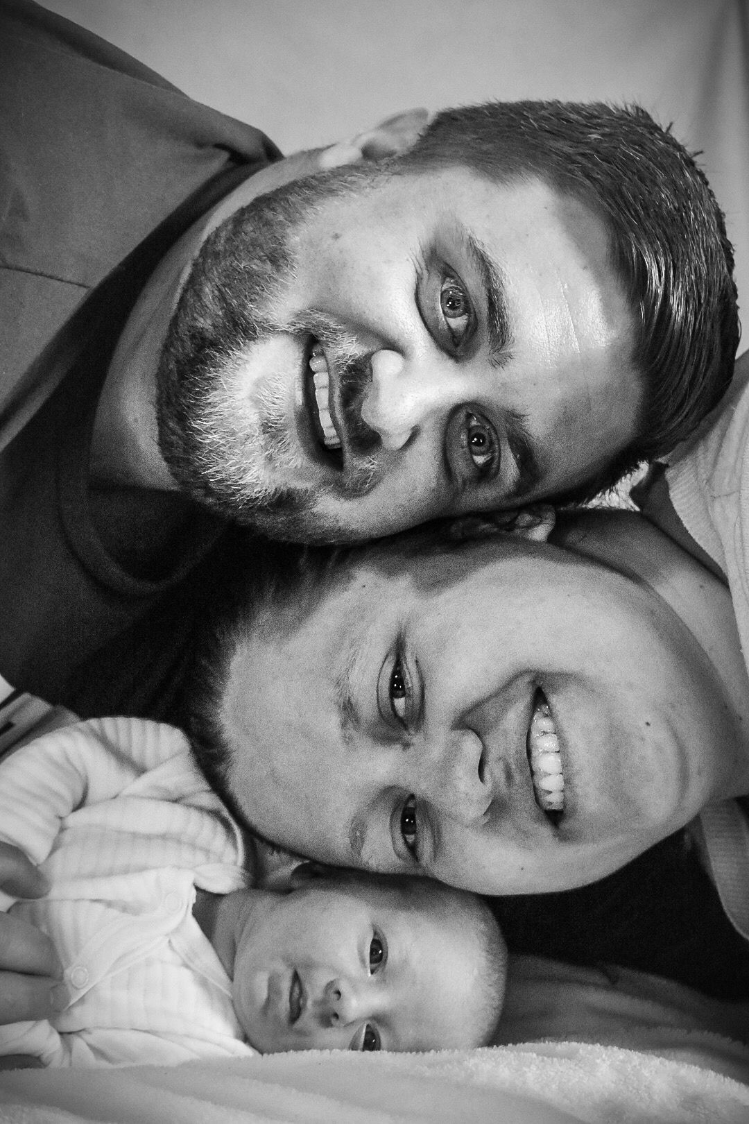 Family portrait of a new family of 3.