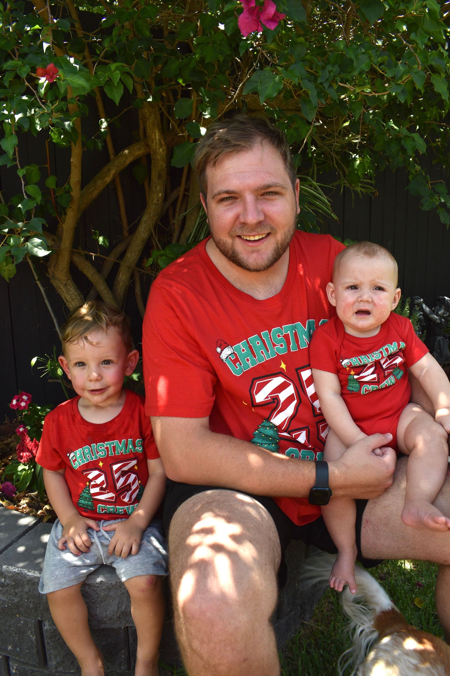 Father and sons captured laughing at a family Christmas party.