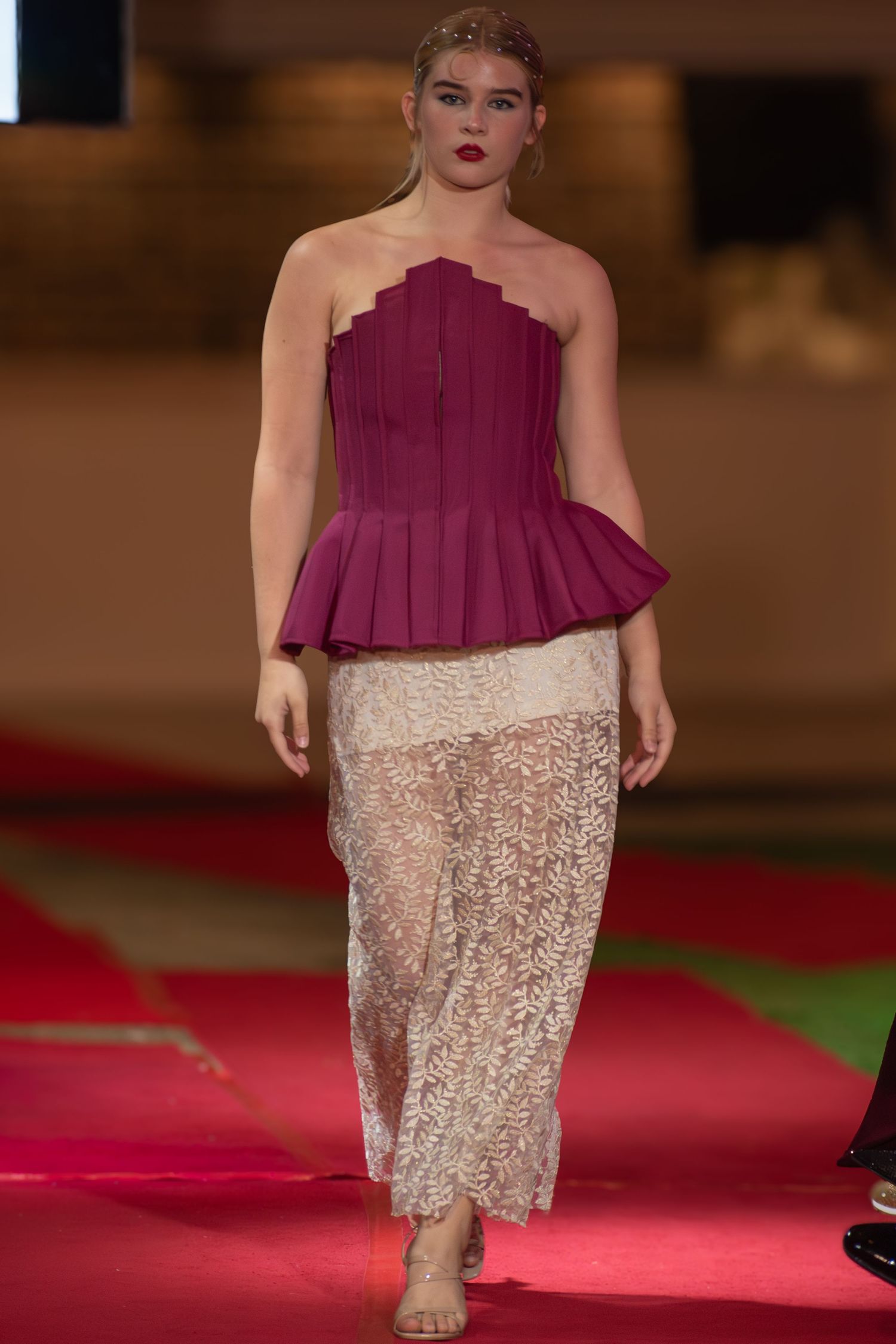 Model walking down the runway at a Brisbane fashion event.