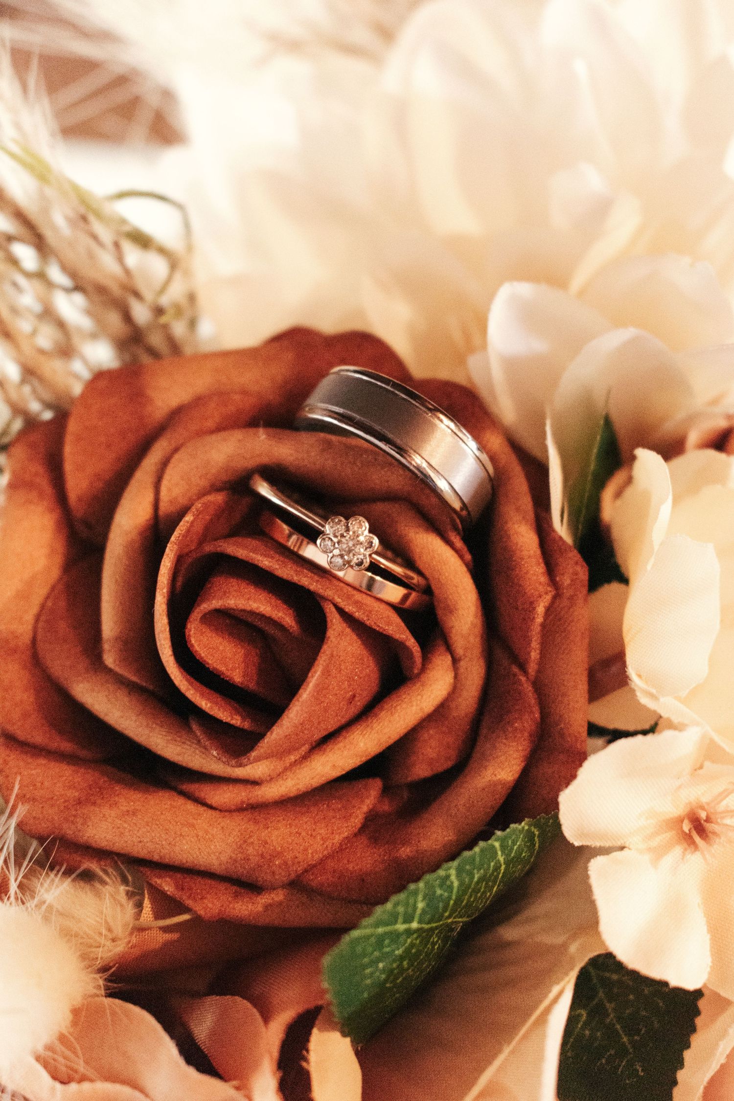 Close-up picture of the wedding bands in the bouqet.