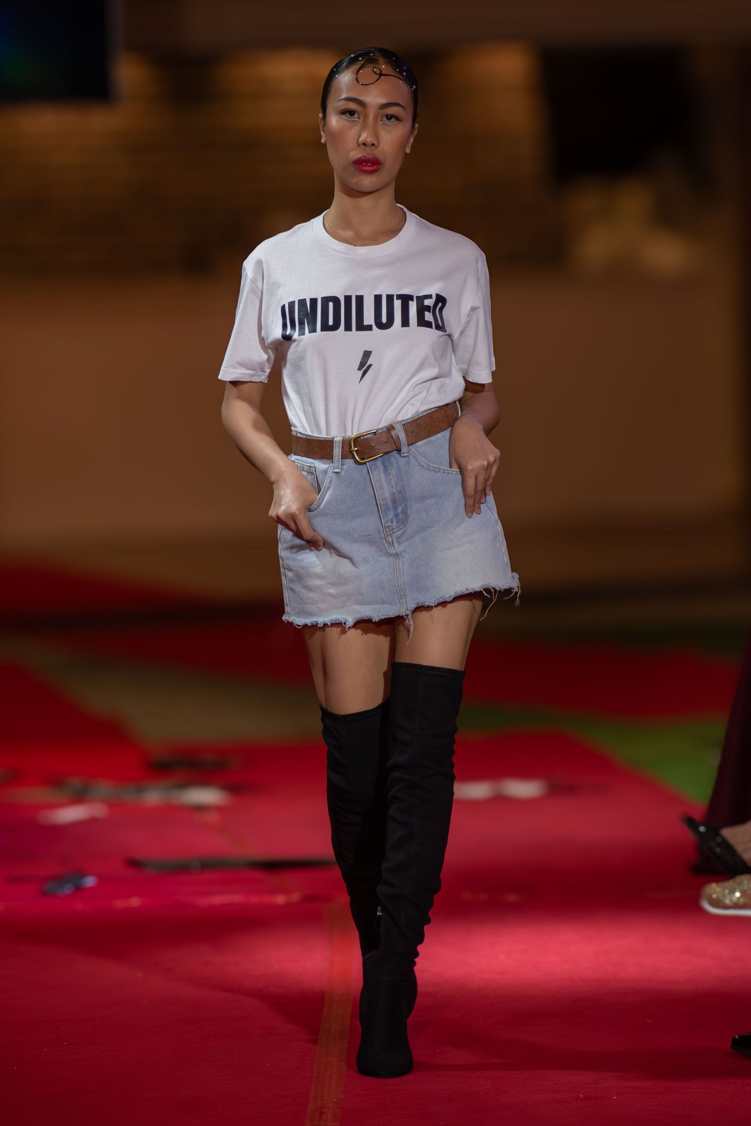 Model walking down the runway at a Brisbane fashion event.