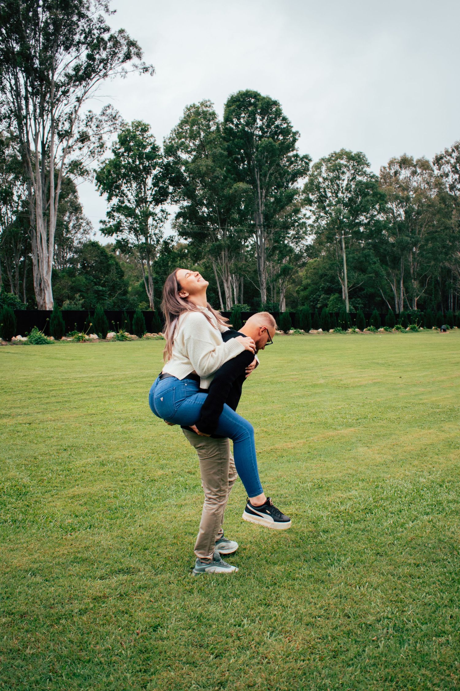 Candid picture of a bride to be getting a piggy back ride.