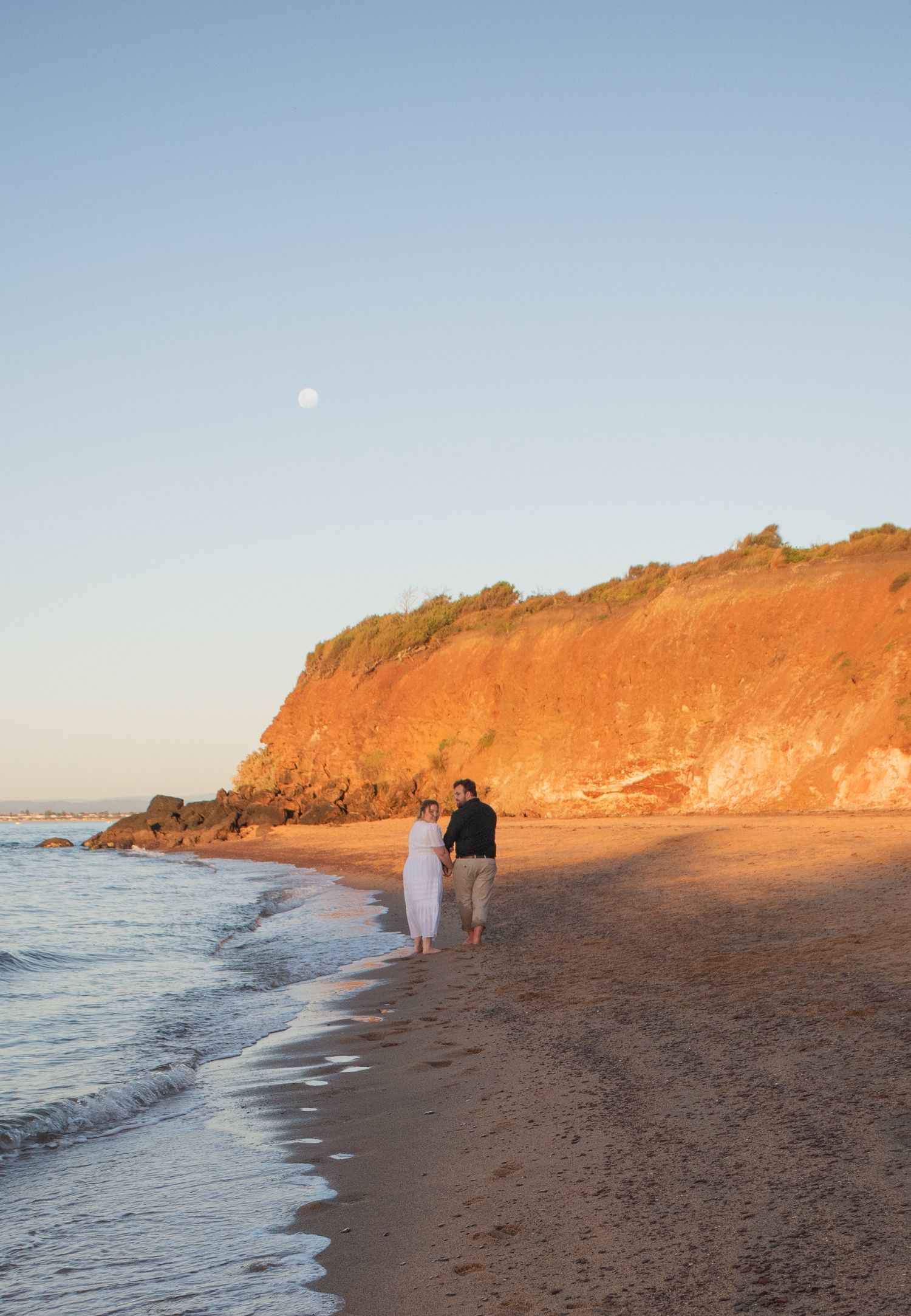 Candid picture of a couple on the beach celebrating their wedding anniversary.