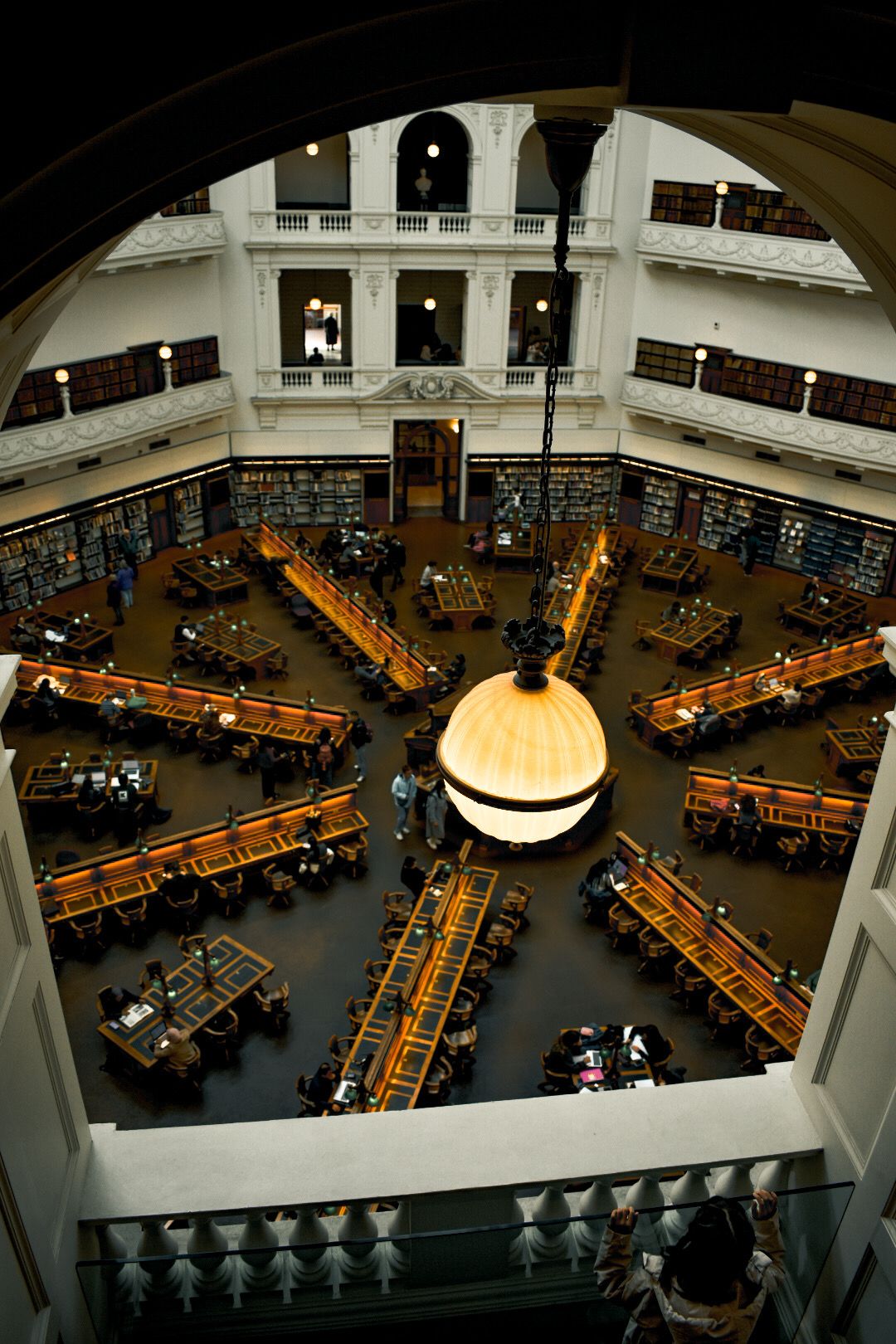Candid photograph of people enjoying a day in the Victoria State Library.