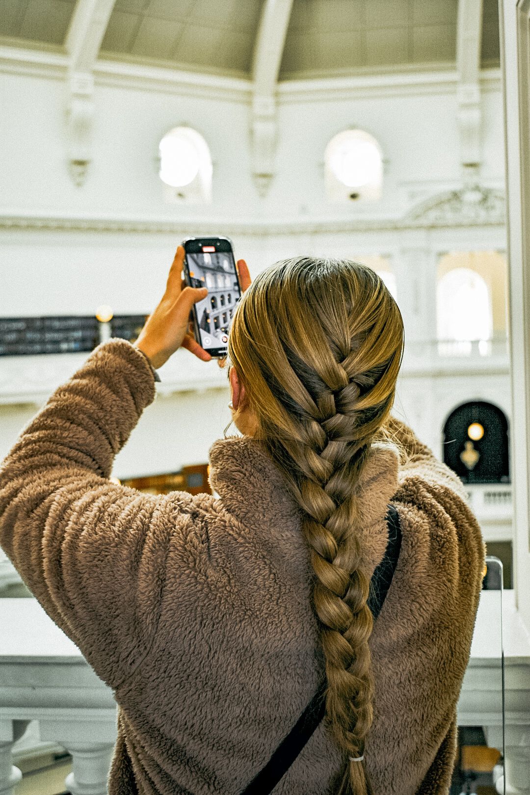 Candid photograph of a tourist capturing new memories.